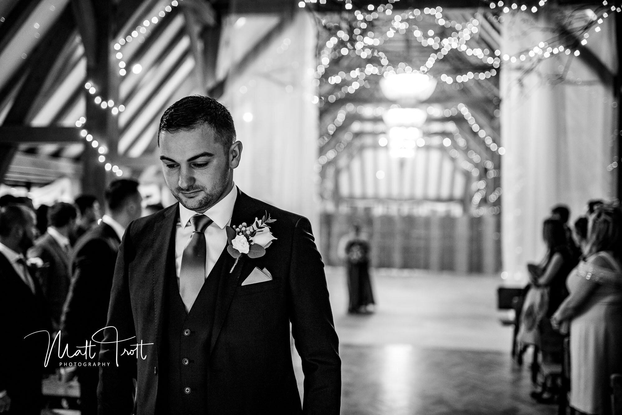 Groom waiting for bride to walk down the aisle at the old kent barn