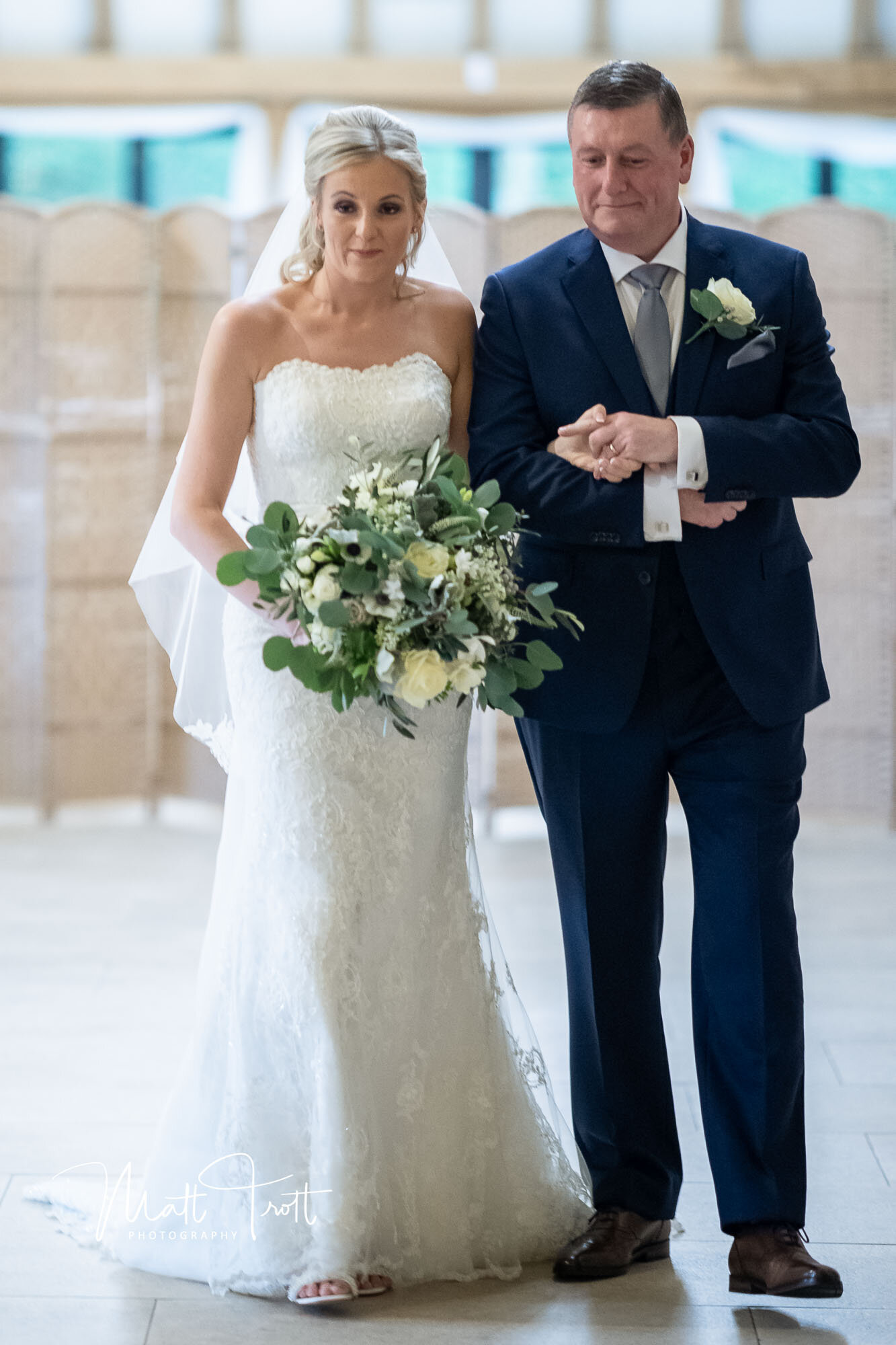 Bride and dad walking down the aisle at the old kent barn