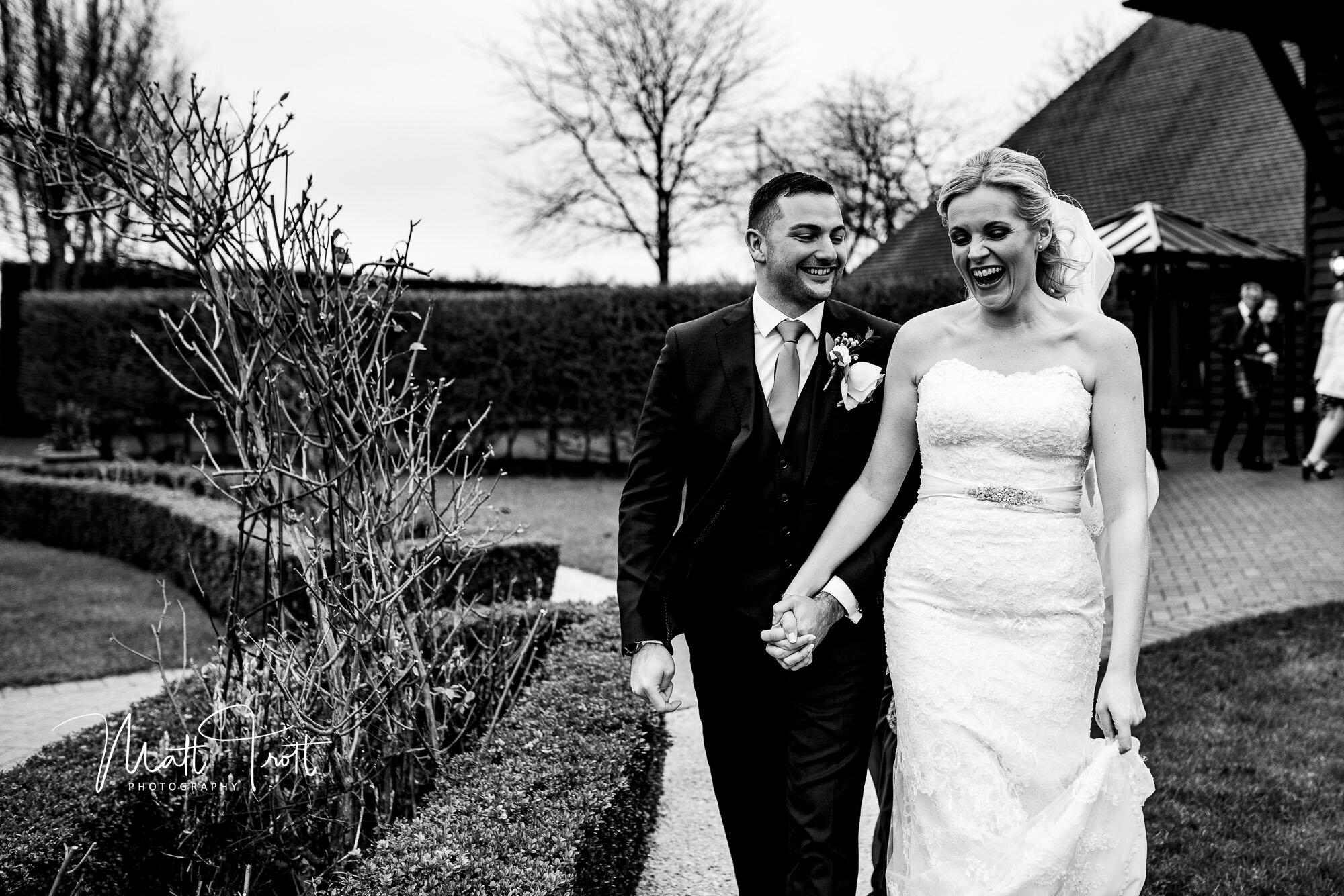 Bride and groom laughing at the old kent barn