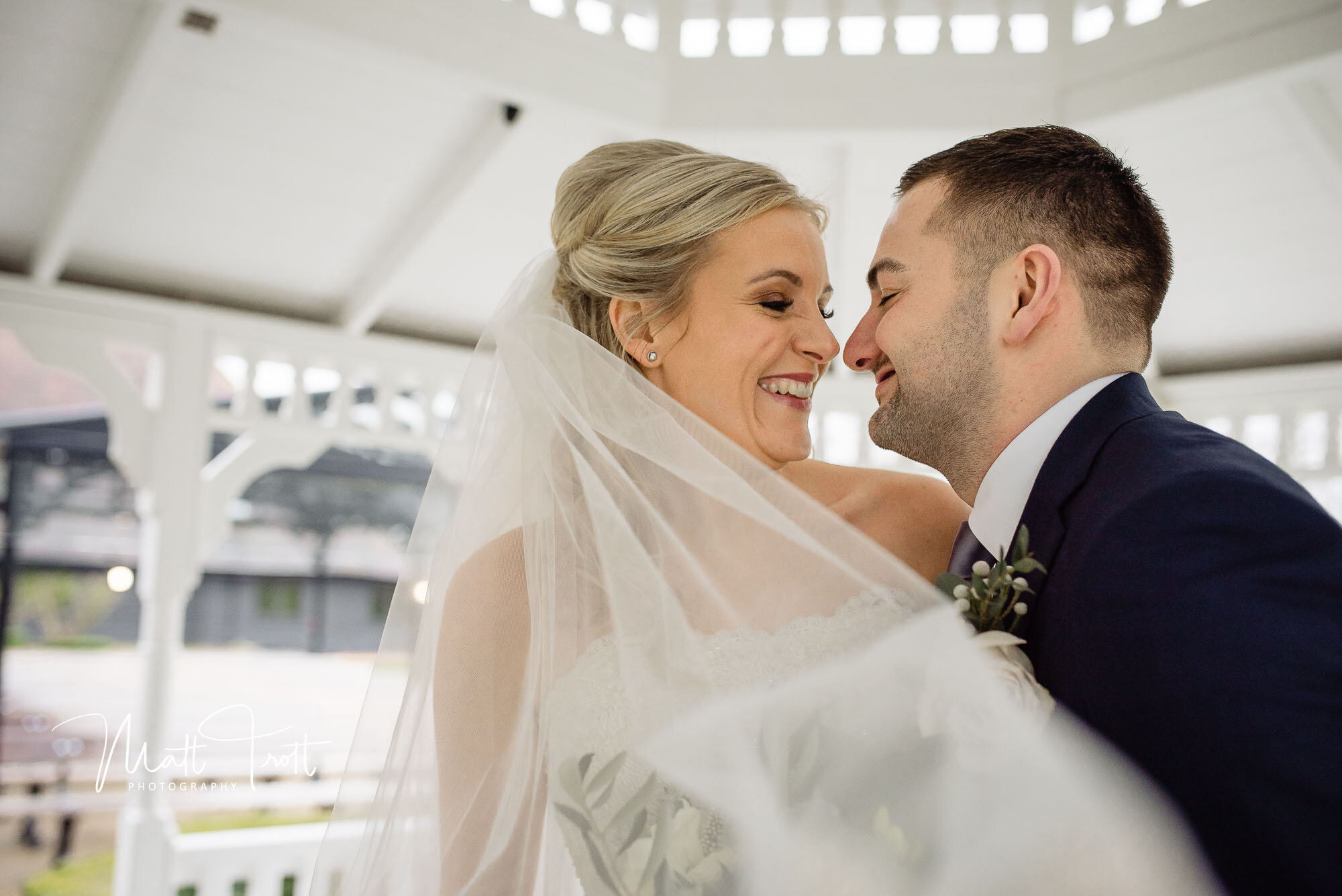 Bride and groom nose to nose at the old kent barn