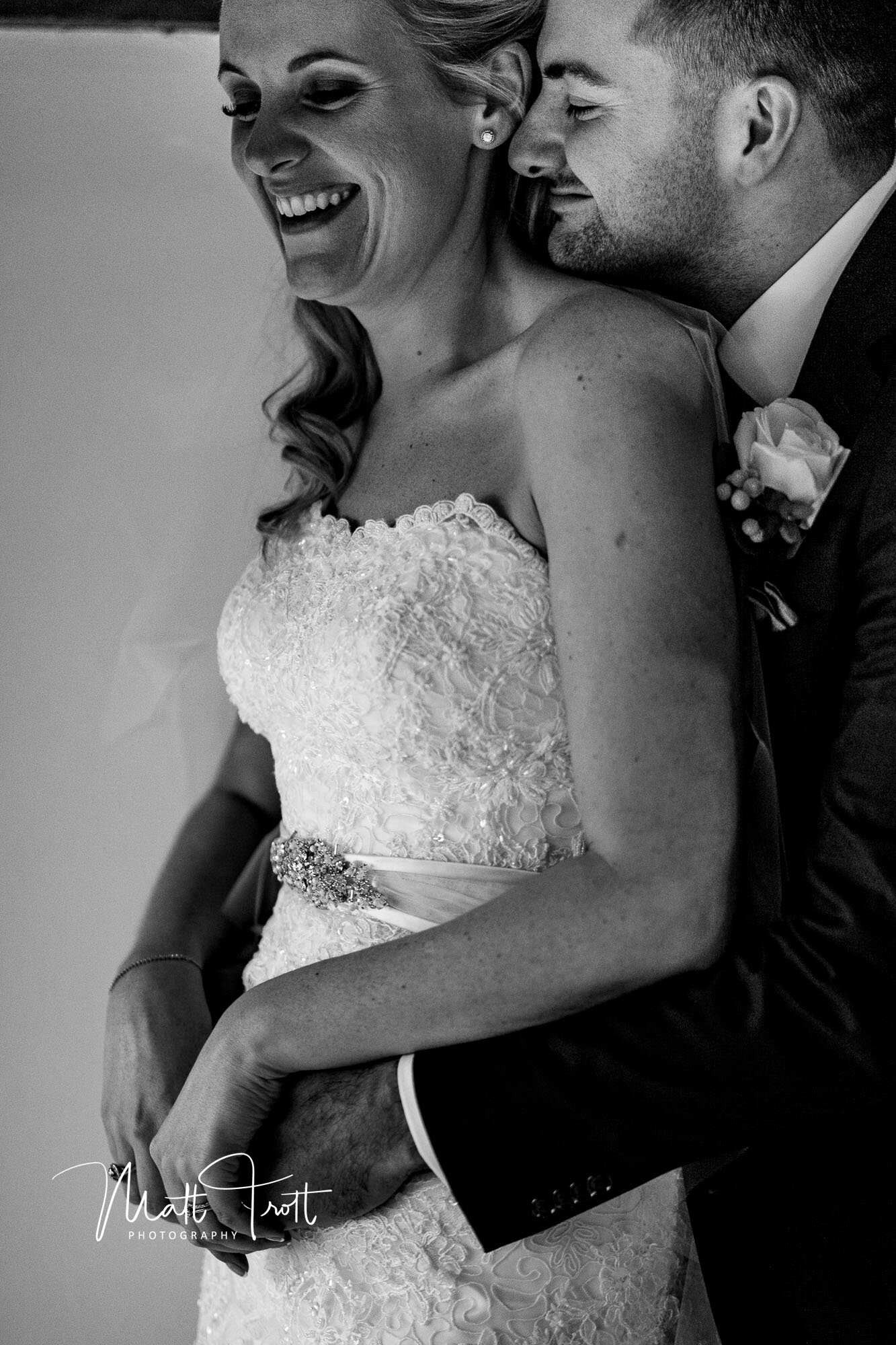 bride and groom cuddling at the old kent barn