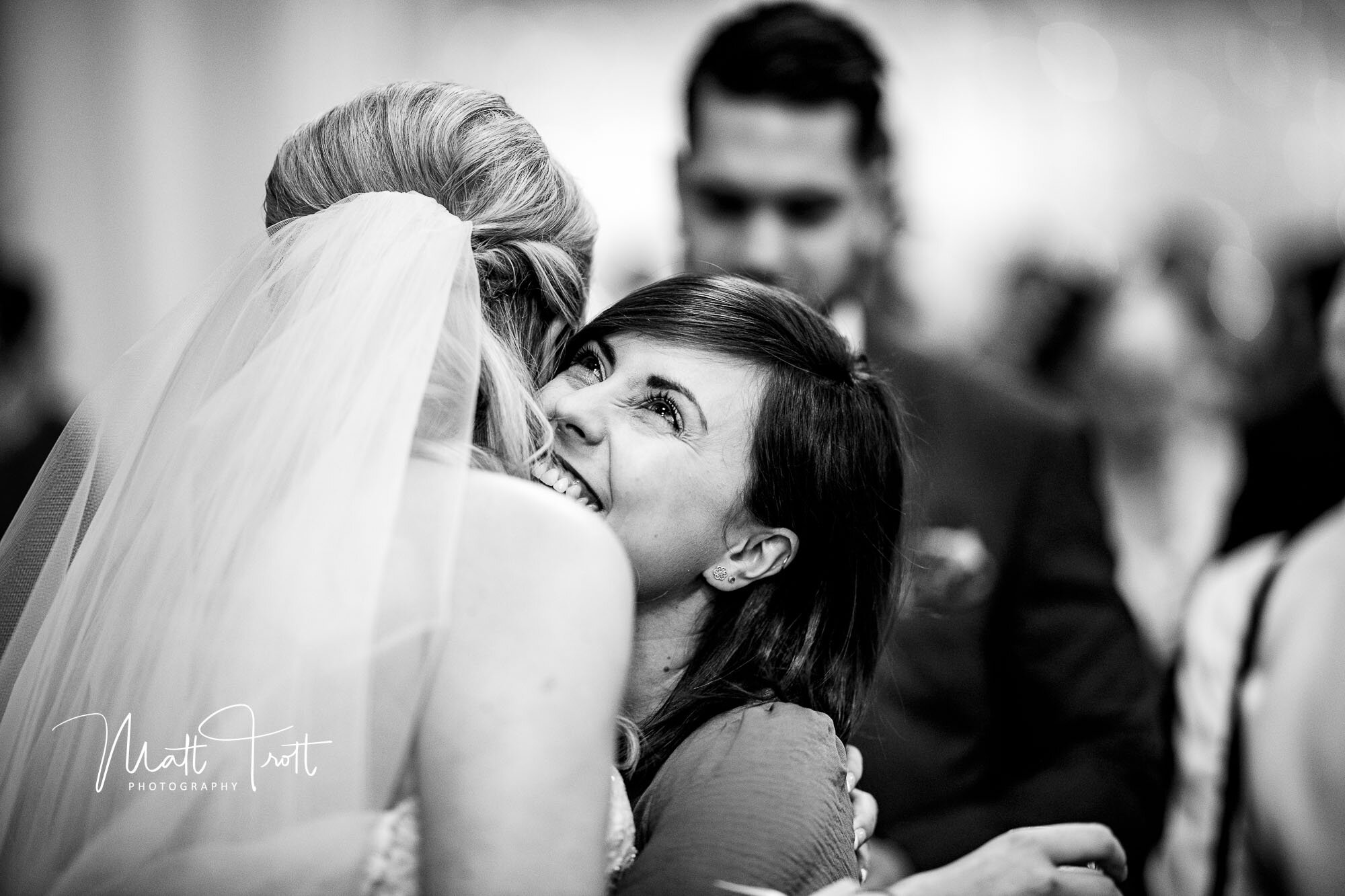 Friend hugging the bride at the old kent barn