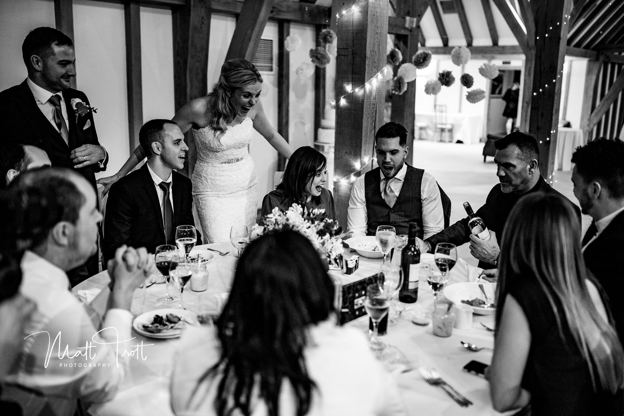 Bride laughing during magic trick at the old kent barn