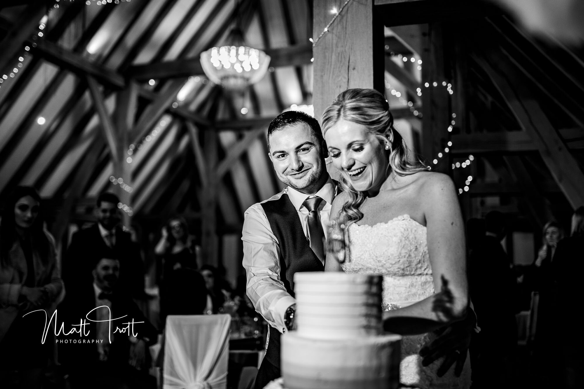 Bride and groom cutting cake at the old kent barn