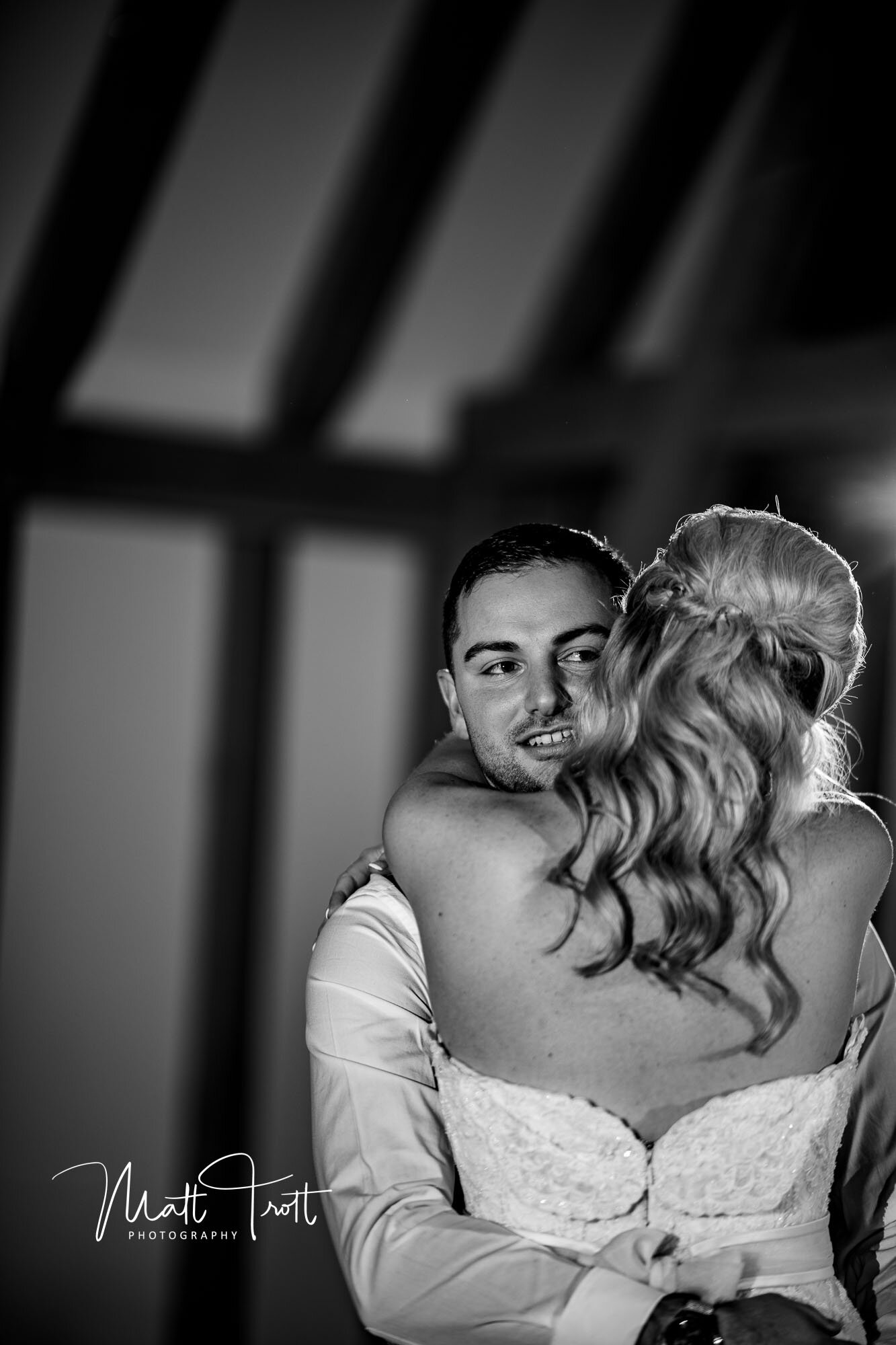 Bride and groom embracing at the old kent barn