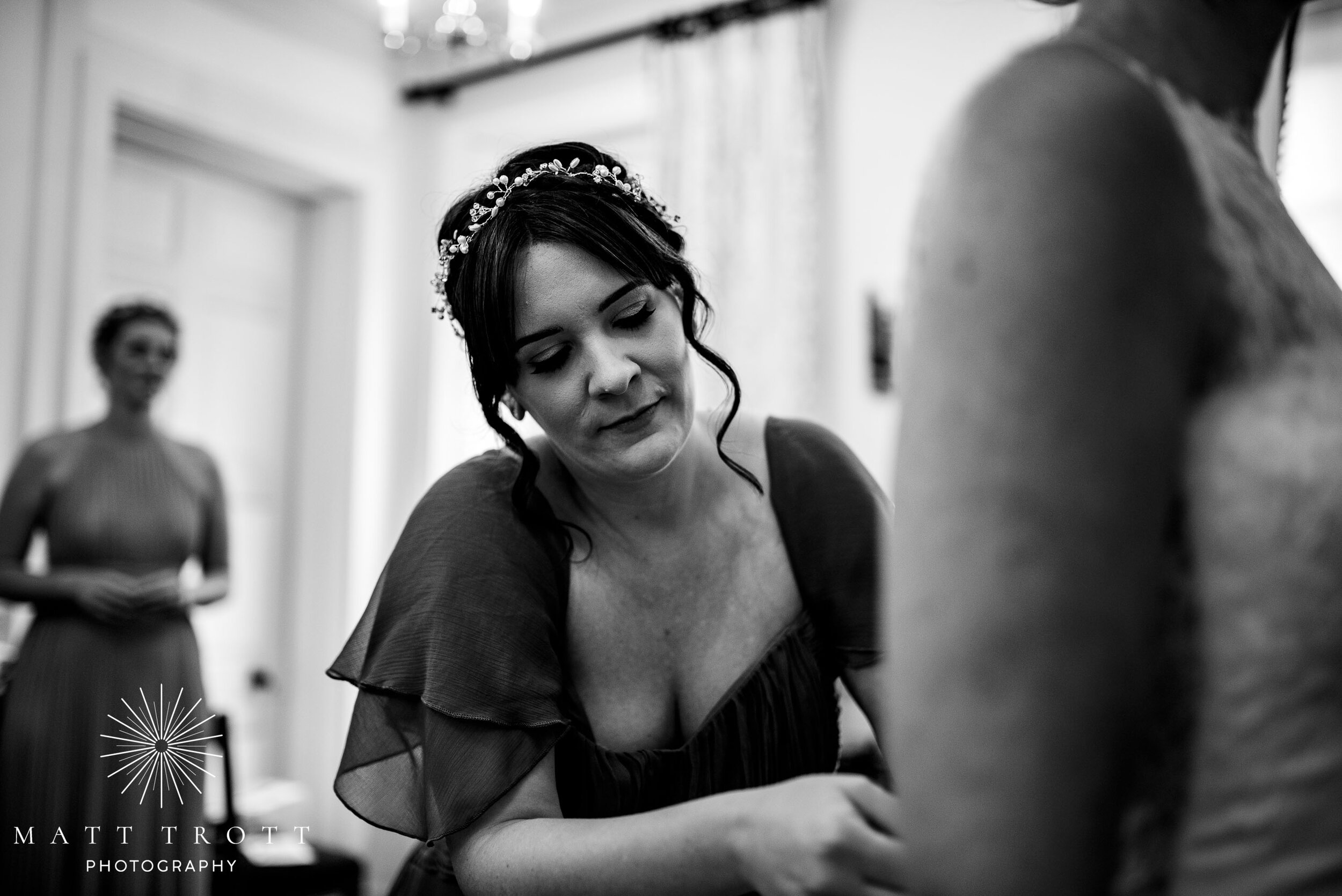 wedding dress being buttoned up at bradbourne house