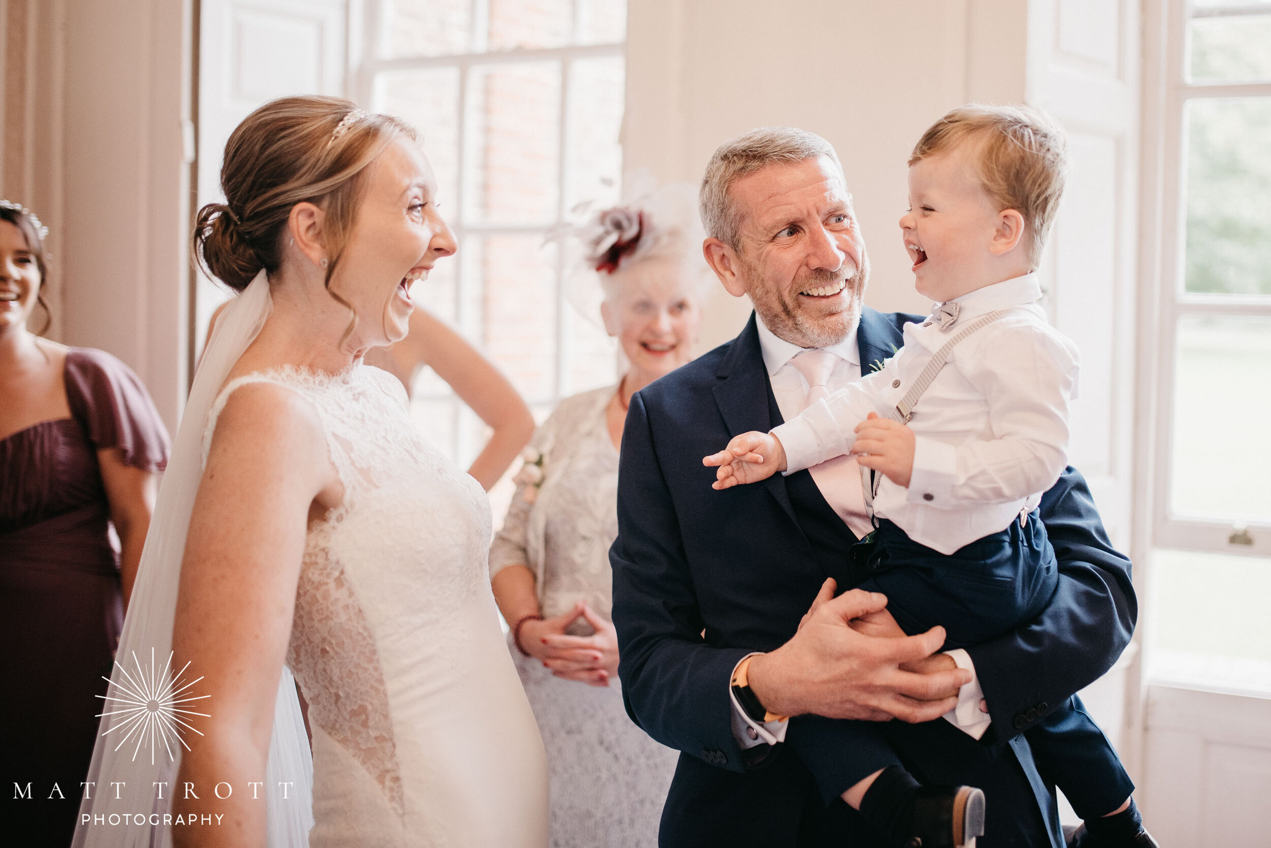 bride and son laughing at bradbourne house during wedding prep