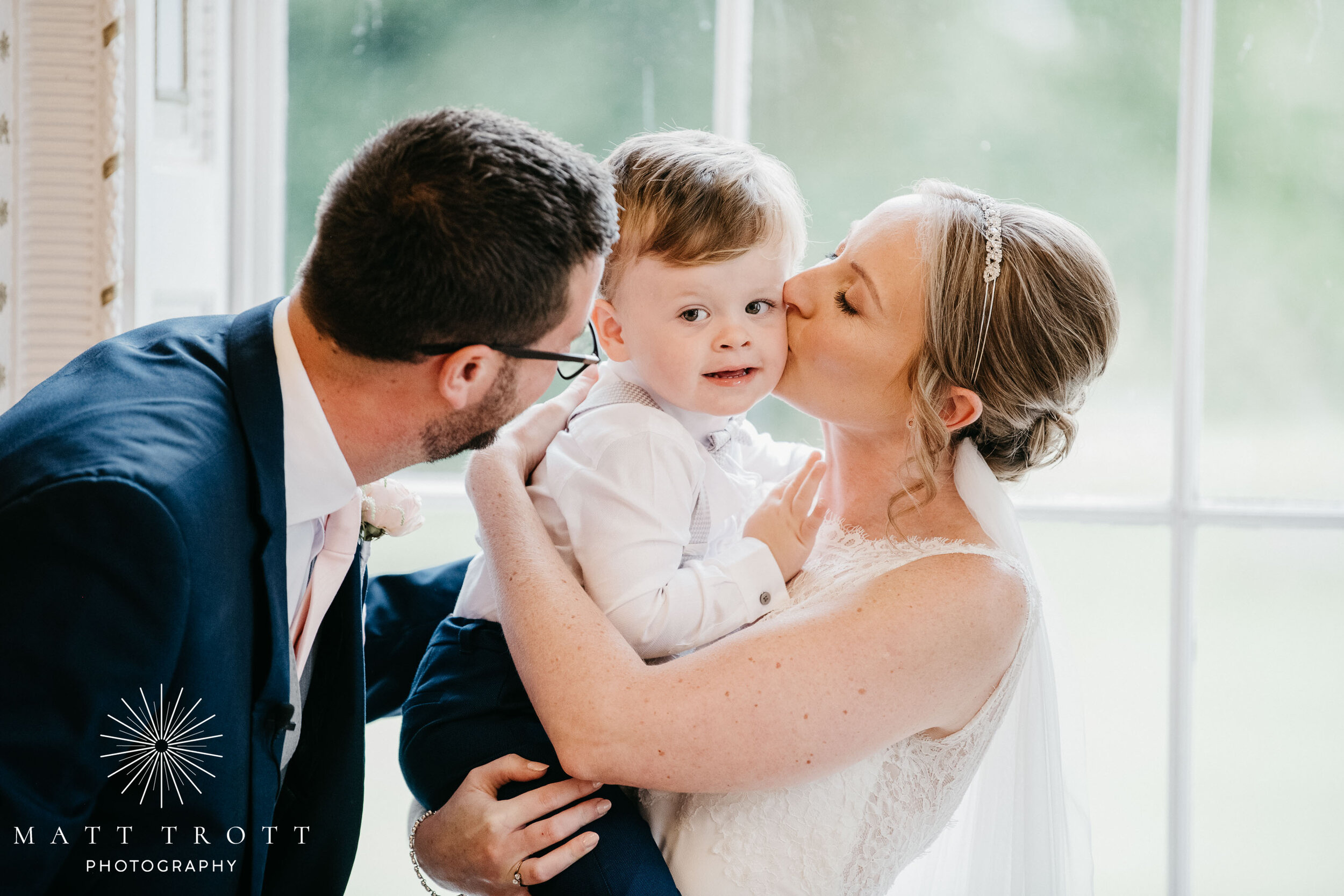 bride groom and son cuddling at bradbourne house