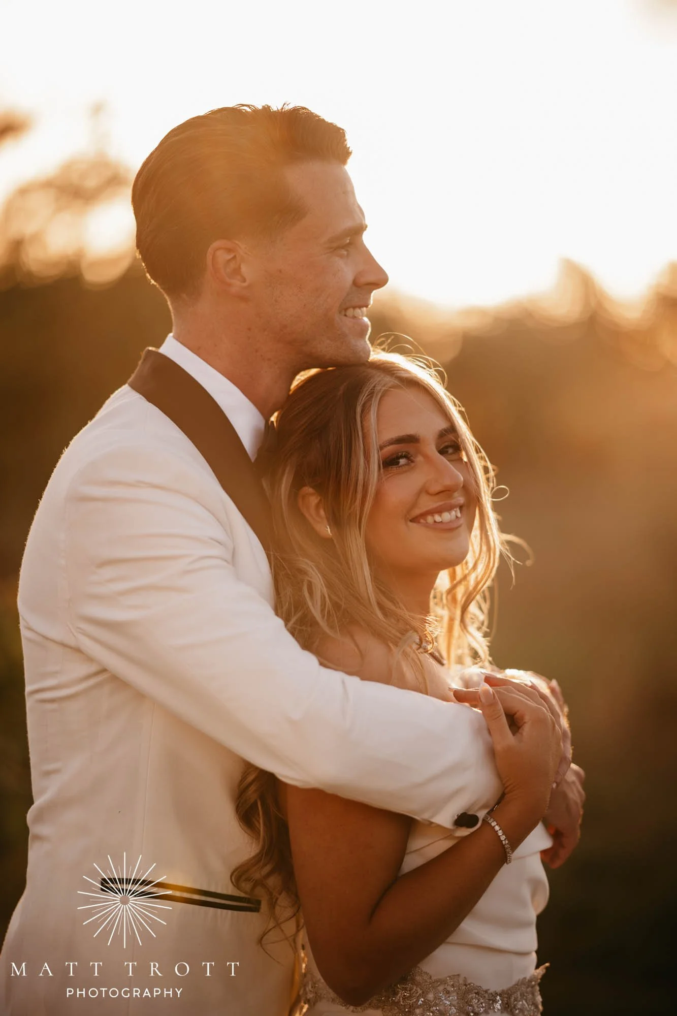 Bride and Groom embraced in a hug during golden hour at their wedding in kent