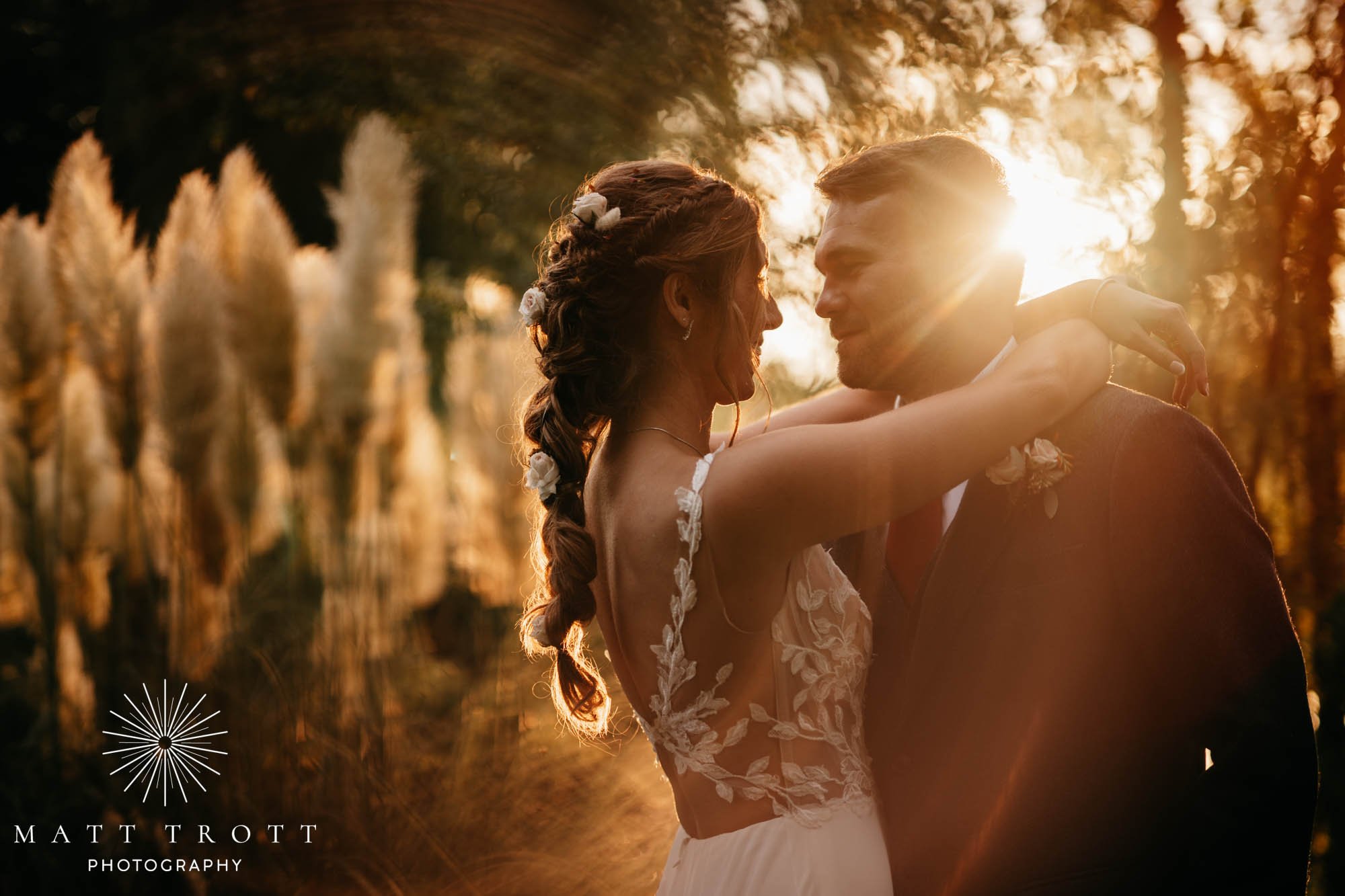 Bride and groom in golden hour at their kent wedding hugging