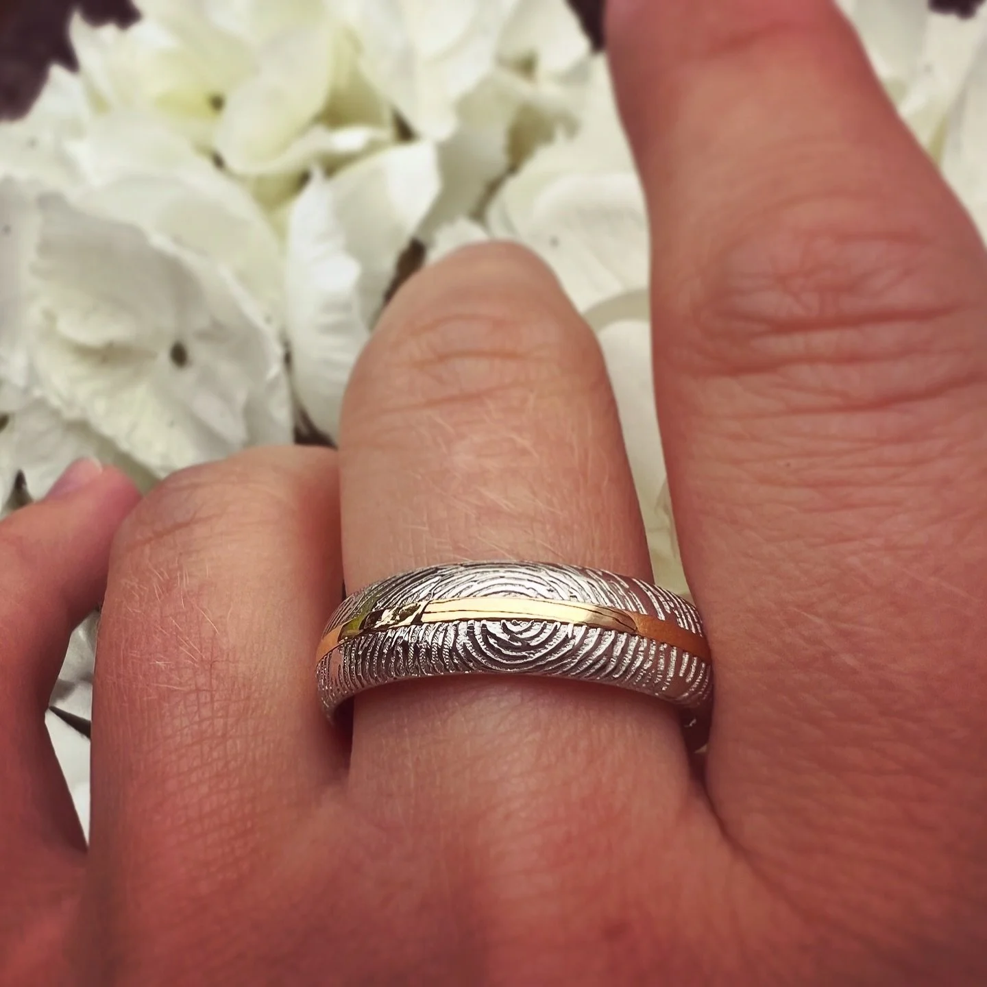 A reworked 22ct gold ring. This beauty was made by melting down an old gold ring and inlaying it into a custom platinum band, designed with the client&rsquo;s wife&rsquo;s fingerprint wrapping its way around it.

The perfect blend of old memories and