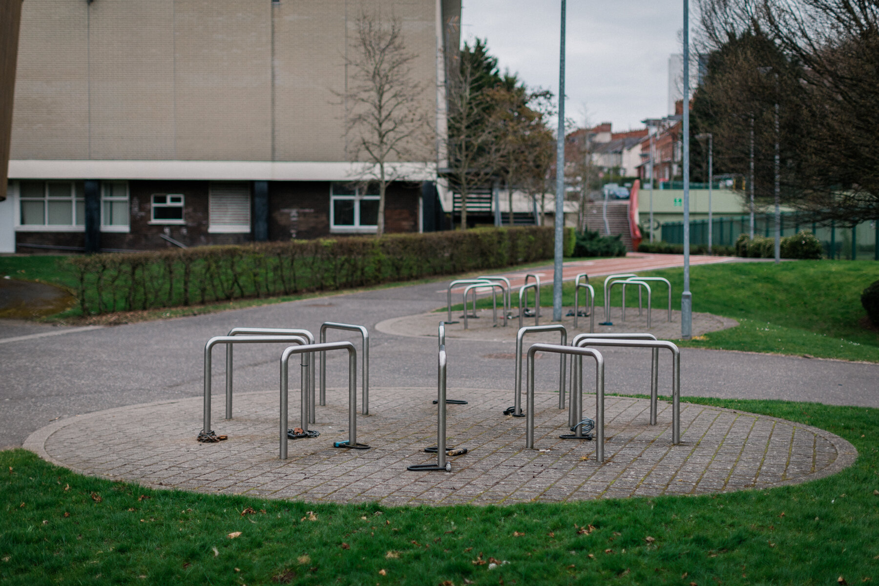 Abandoned bike chains hang off empty bike racks outside Botanic Gardens, Belfast.