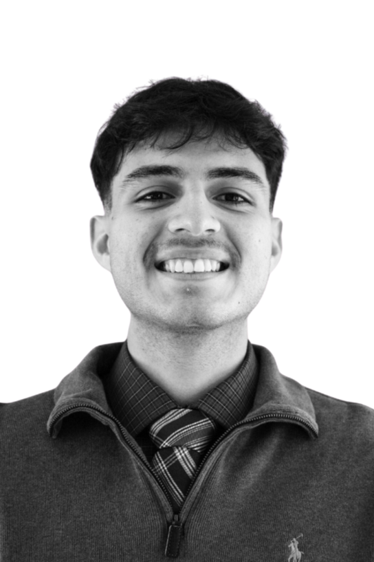 Black and white portrait of a smiling young man with short dark hair, wearing a crewneck shirt, against a plain light background.