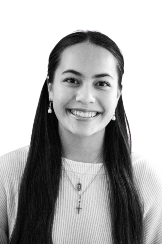 Black and white portrait of a smiling young woman with curly hair, wearing a dark sweater and a necklace, against a plain background.