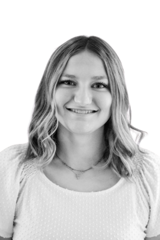 Black and white portrait of a young woman with shoulder-length hair smiling, wearing a t-shirt with 'Oregon State' printed on it.