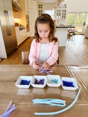 White pipe cleaner snowflake craft with pony beads