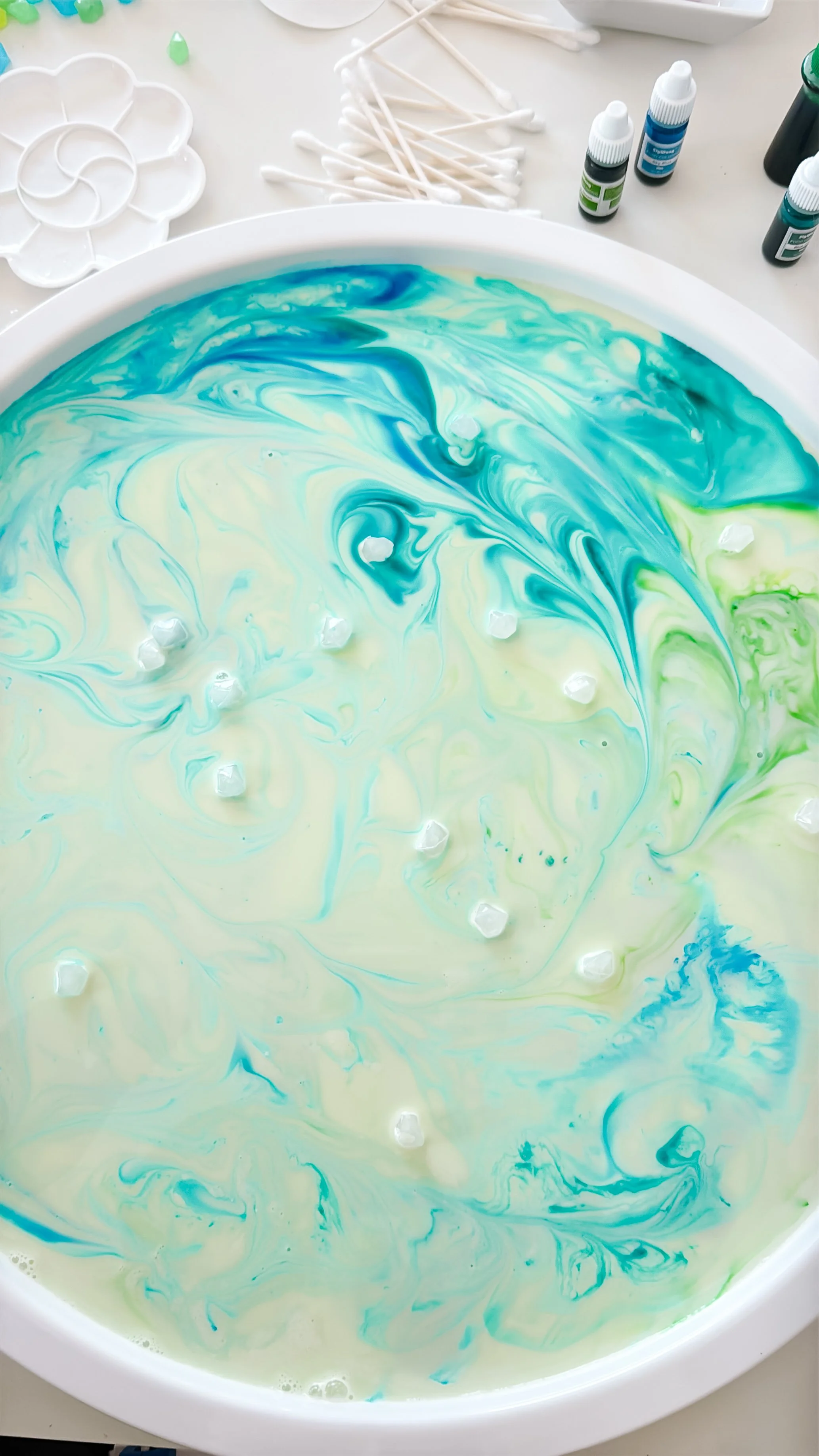 Blue and green Magic Milk colors forming aurora-like swirls and ribbons.