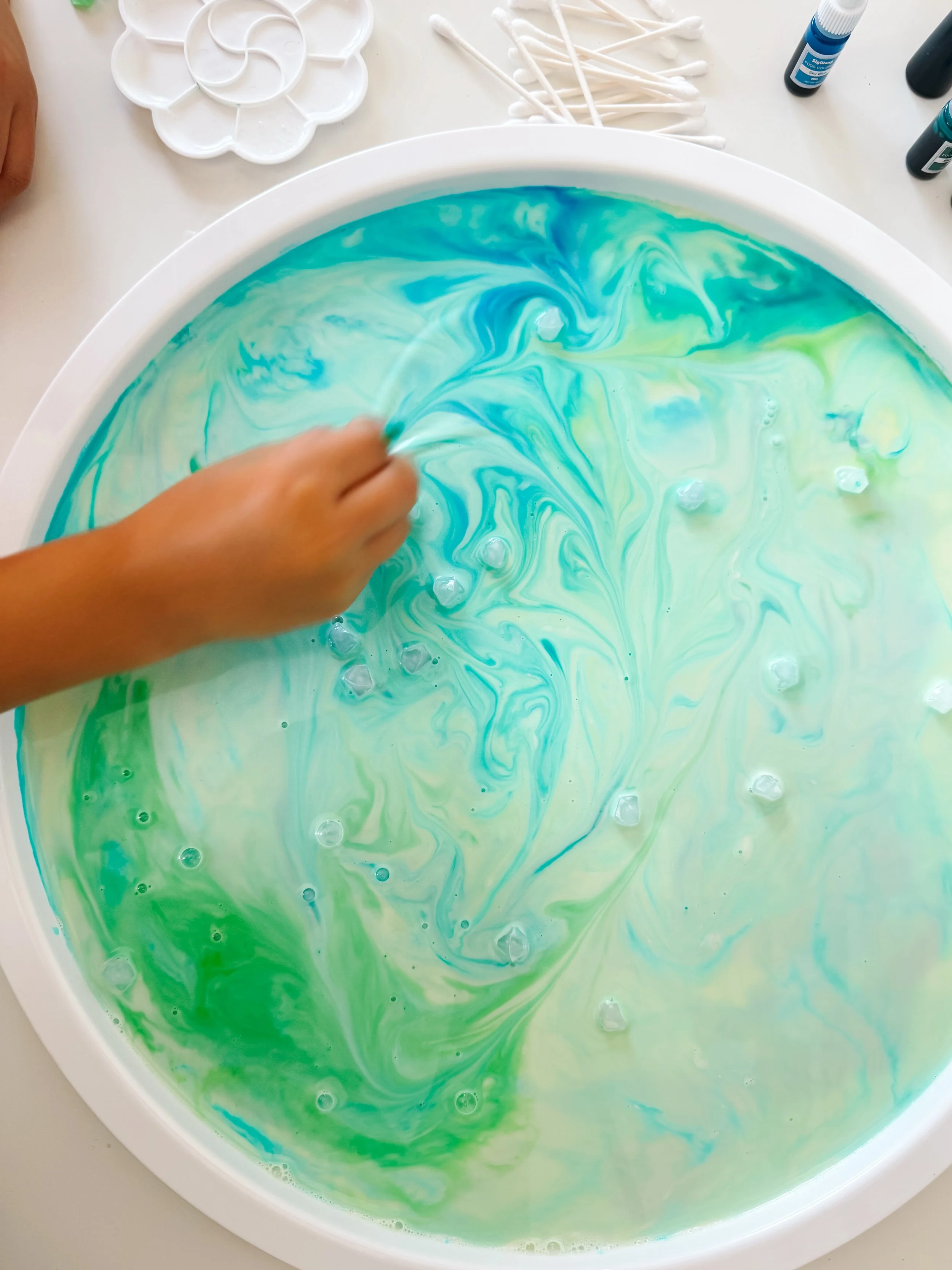 Finished Northern Lights Magic Milk tray with large swirls of teal, turquoise, blue, and green.