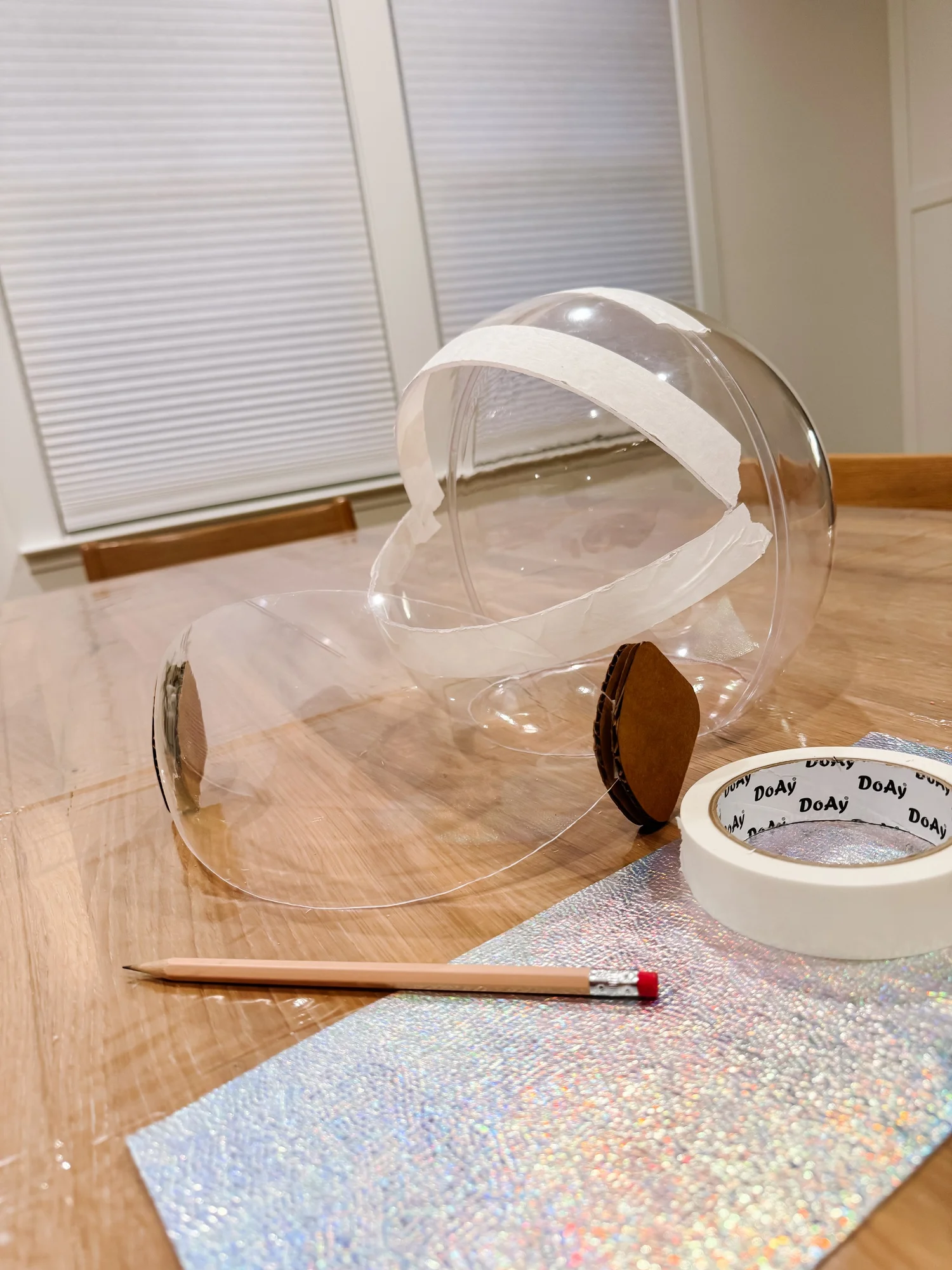 Clear globe marked with tape before cutting the helmet opening