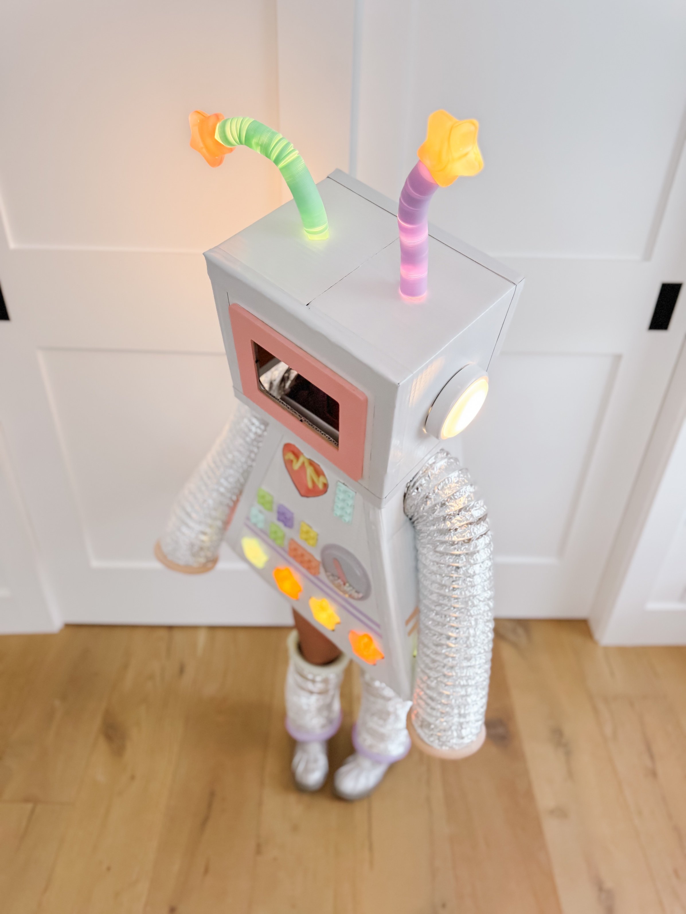 Toddler robot costume with lights on at night while trick-or-treating