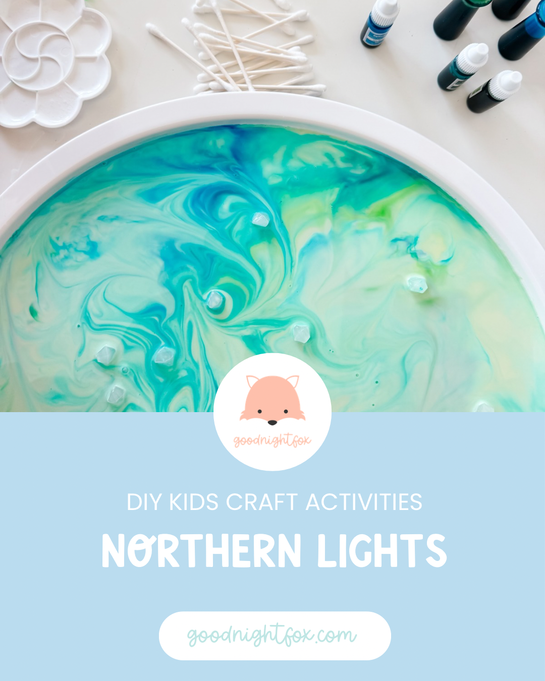 Northern Lights Magic Milk experiment with swirling blue and green colors in a white sensory tray.