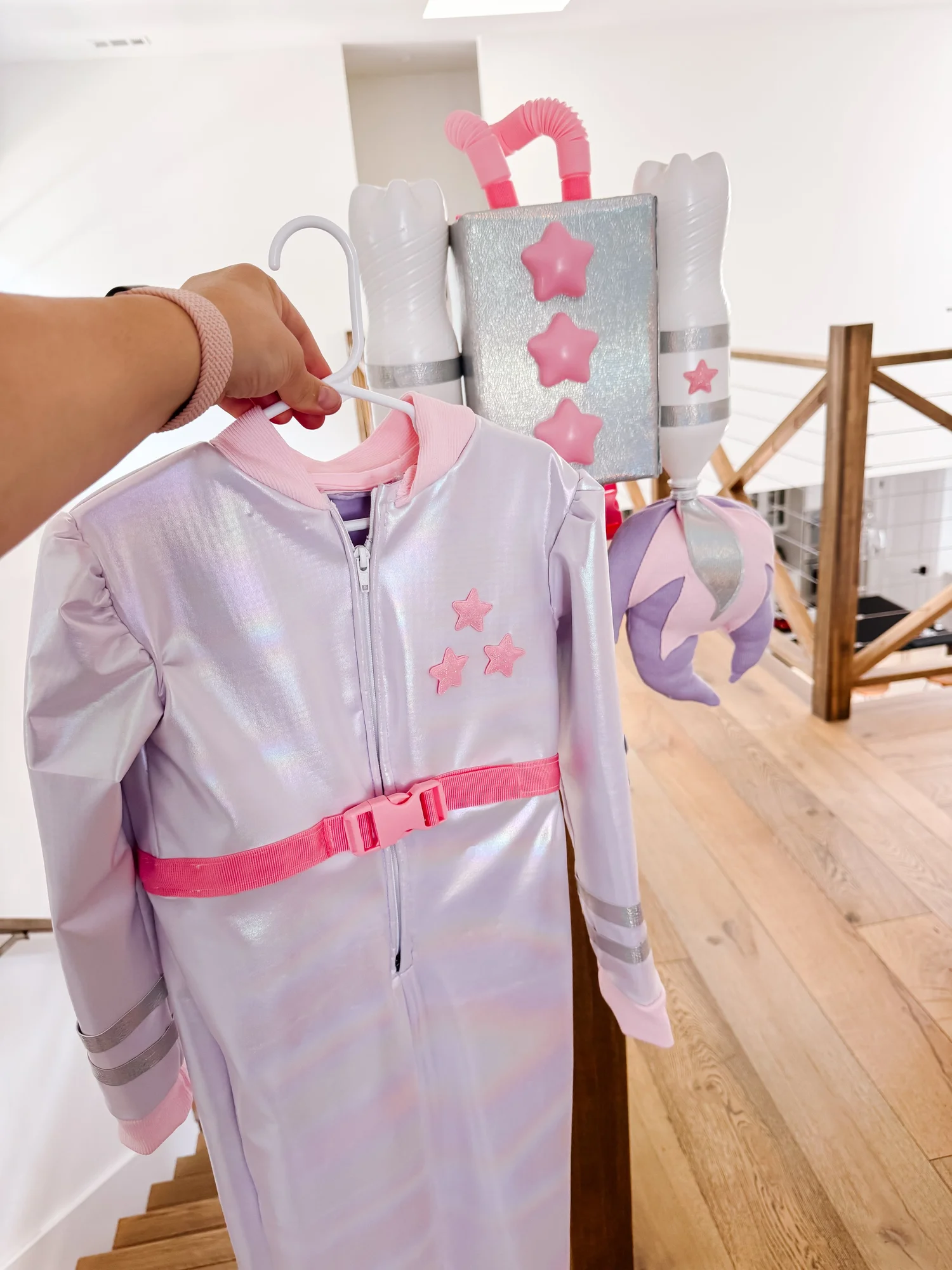Holographic pastel spacesuit laid out during construction
