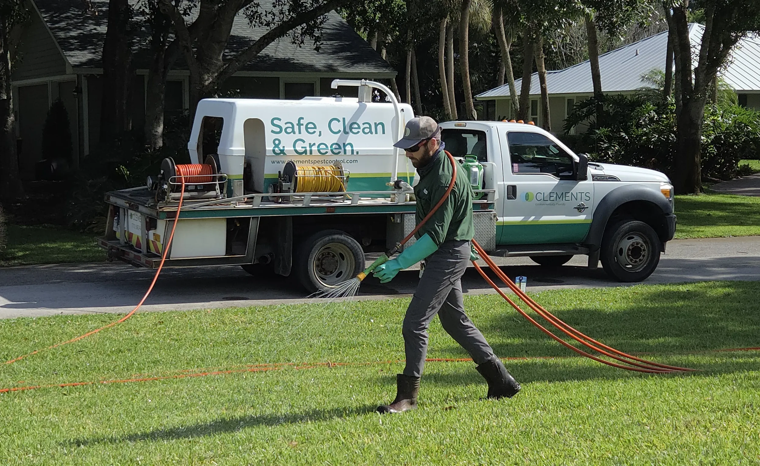 clements-pest-control-lawn-tech-treating-st-augustine-lawn.webp