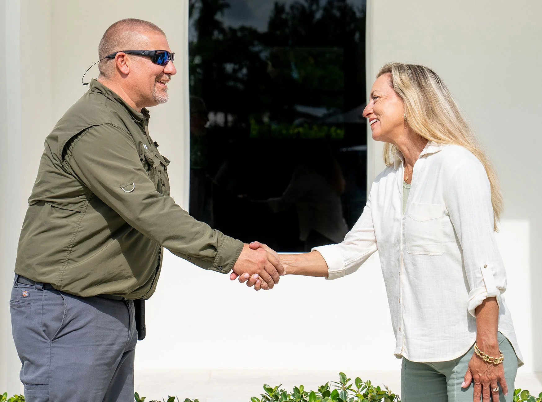 Technician greeting customer outside a Stuart, FL home.