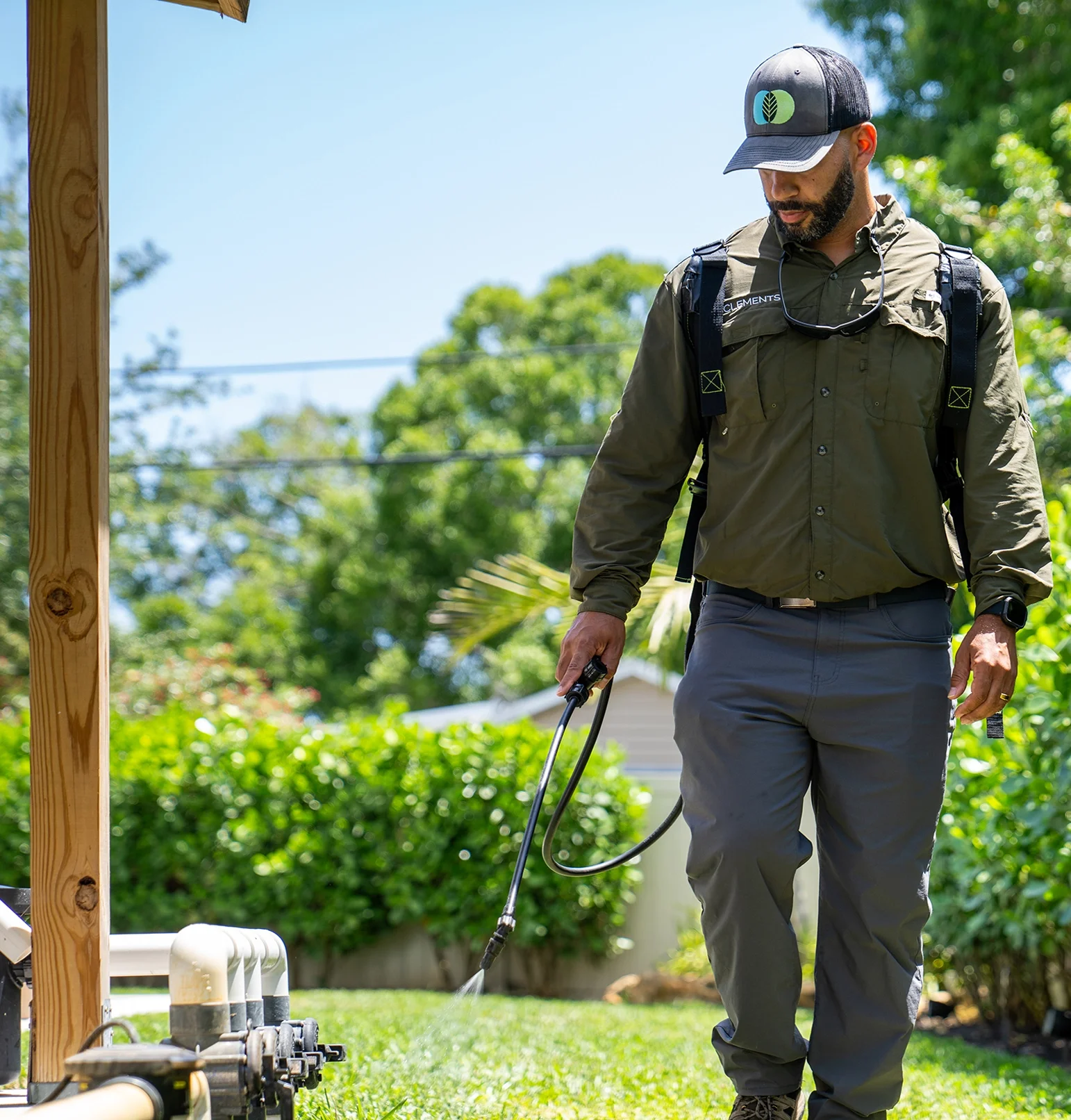 Clements technician treating home perimeter for pest protection.