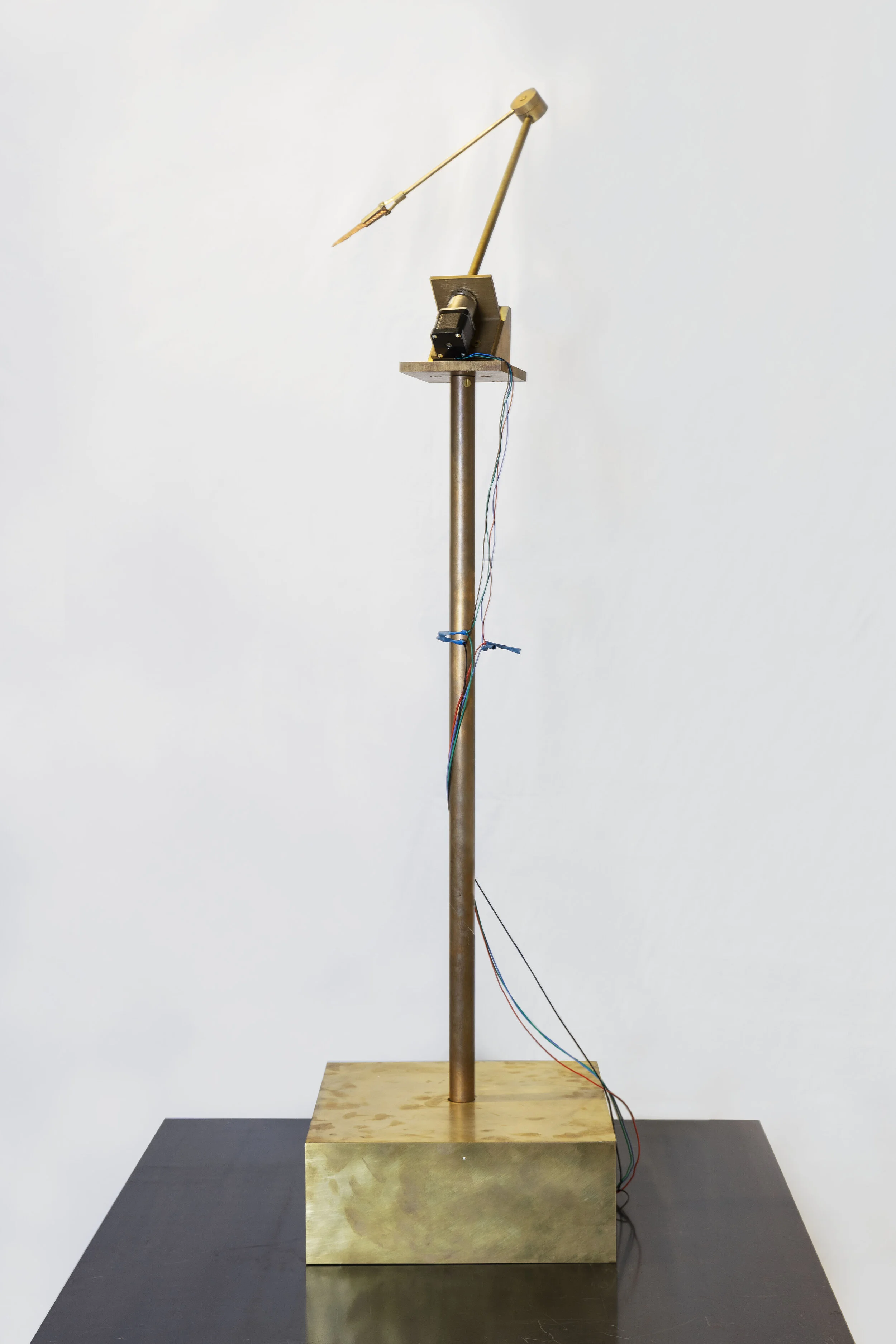 Atlas Brass, rotation motor, Neolithic Dalton point, electronics, wood 120 x 40 x 40 cm 2019