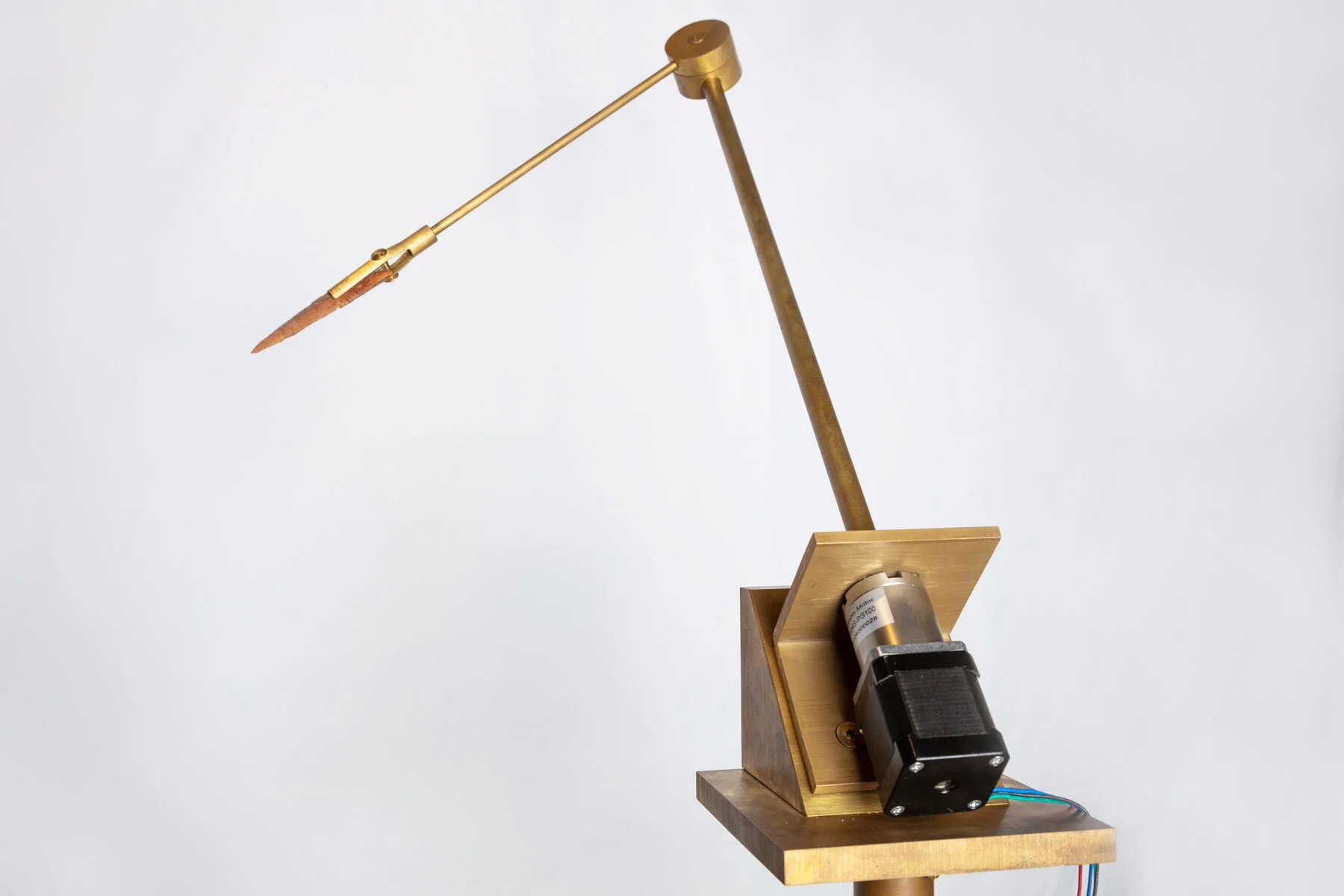 Atlas (detail) Brass, rotation motor, Neolithic Dalton point, electronics, wood 120 x 40 x 40 cm 2019