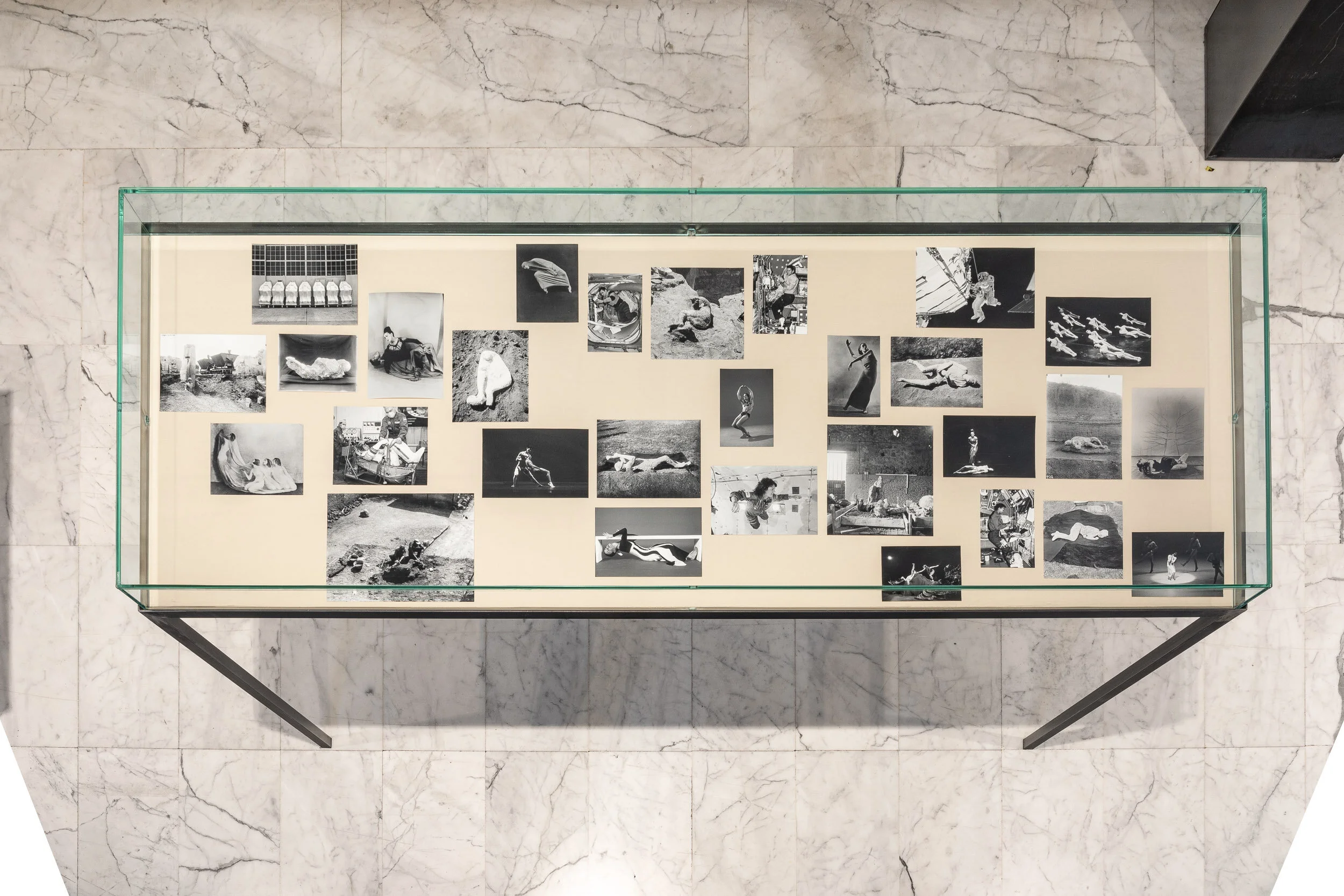 Attitude 2 Steel and glass vitrine, black and white photographs, fabric 100 x 210 x 75 cm 2019