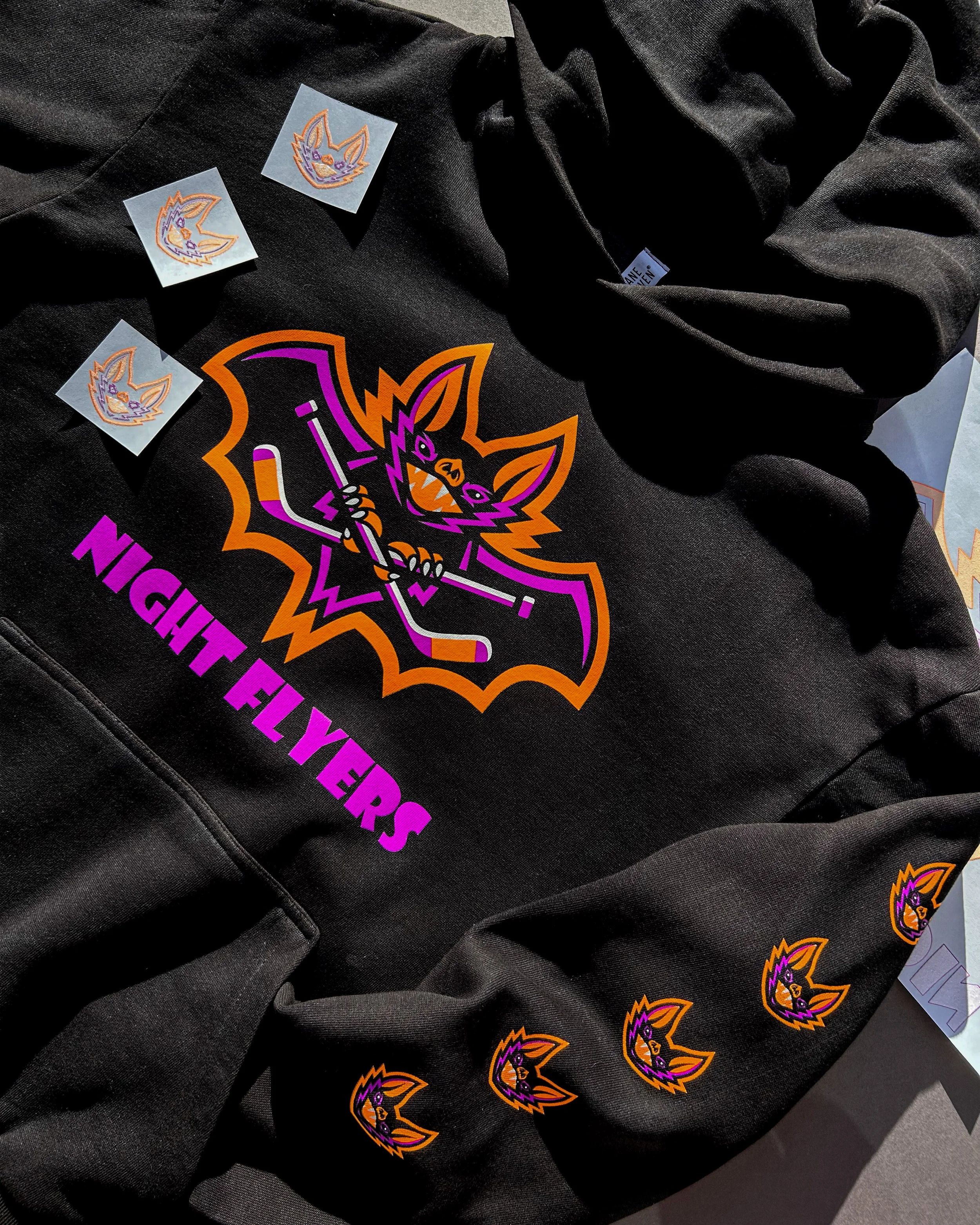 Black Lane Seven Urban Hoodie printed with Night Flyers hockey artwork in Neon Orange, Neon Purple and White Howard Multi-Purpose.