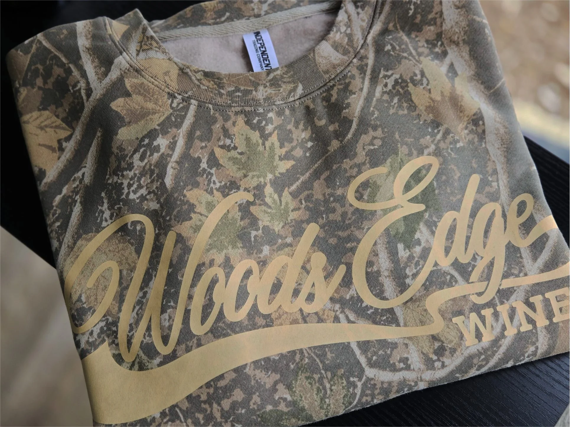 Folded Woods Edge Winery camo crewneck with Light Tan Vintage Wash lettering designed as destination merchandise.