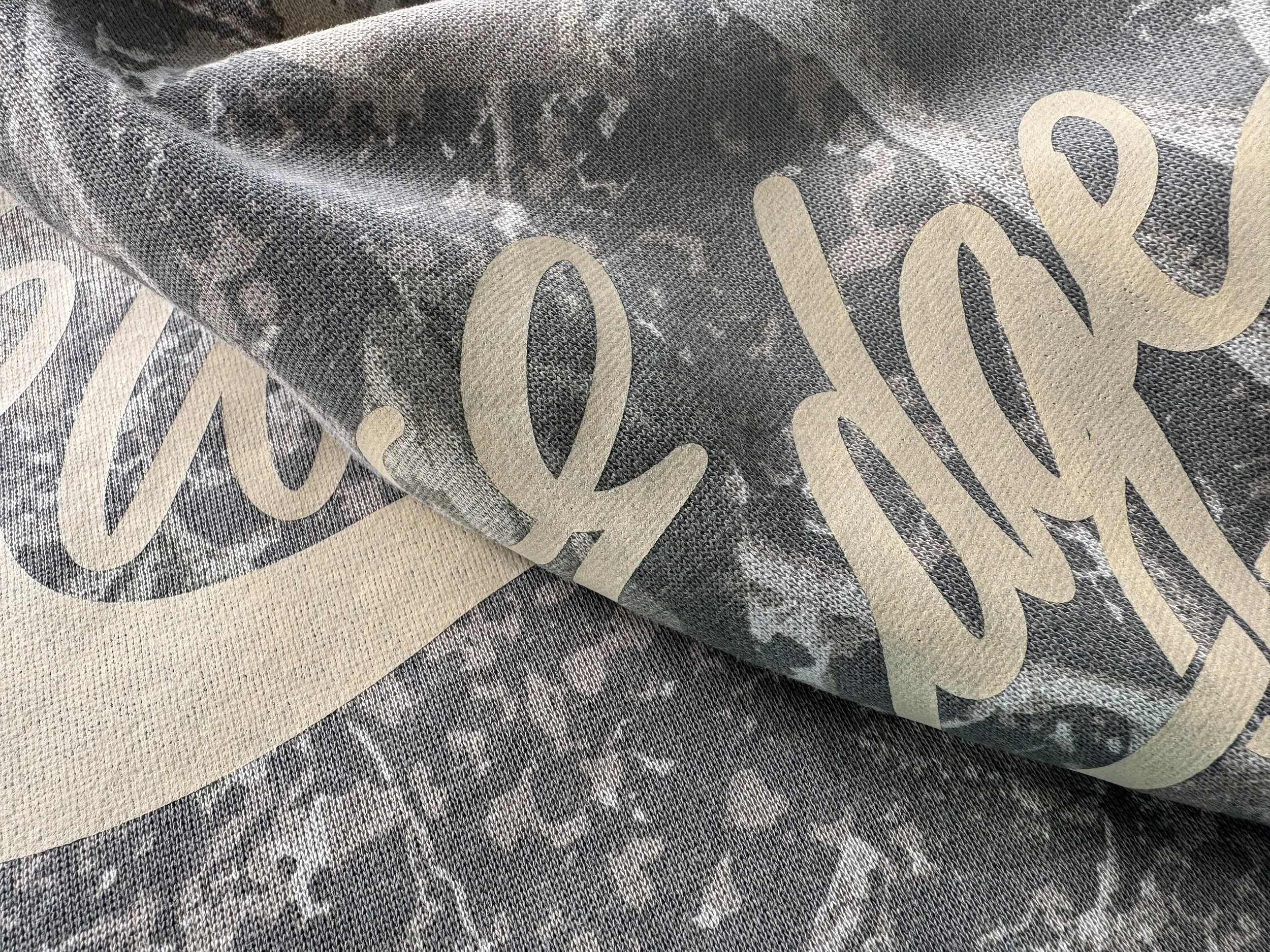 Light Tan Vintage Wash allows the Deadwood Tree camo pattern to show through the Woods Edge Winery lettering.