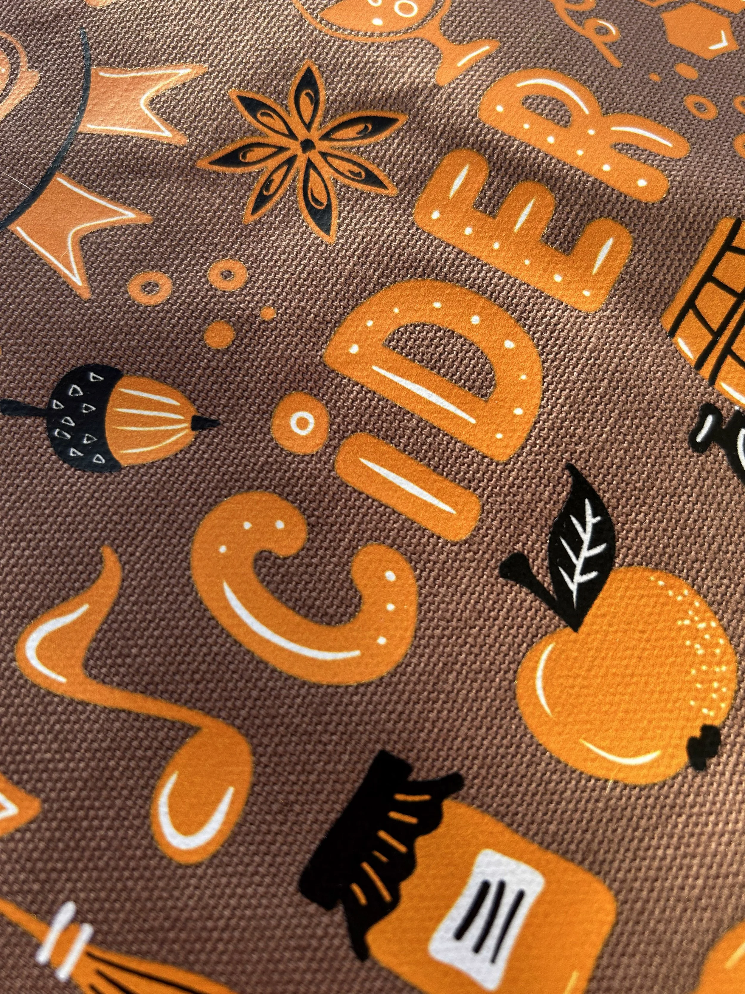Close-up of orange, black and white Harvest Cider Fest colorVIBE DTF artwork on a brown Comfort Colors tote.