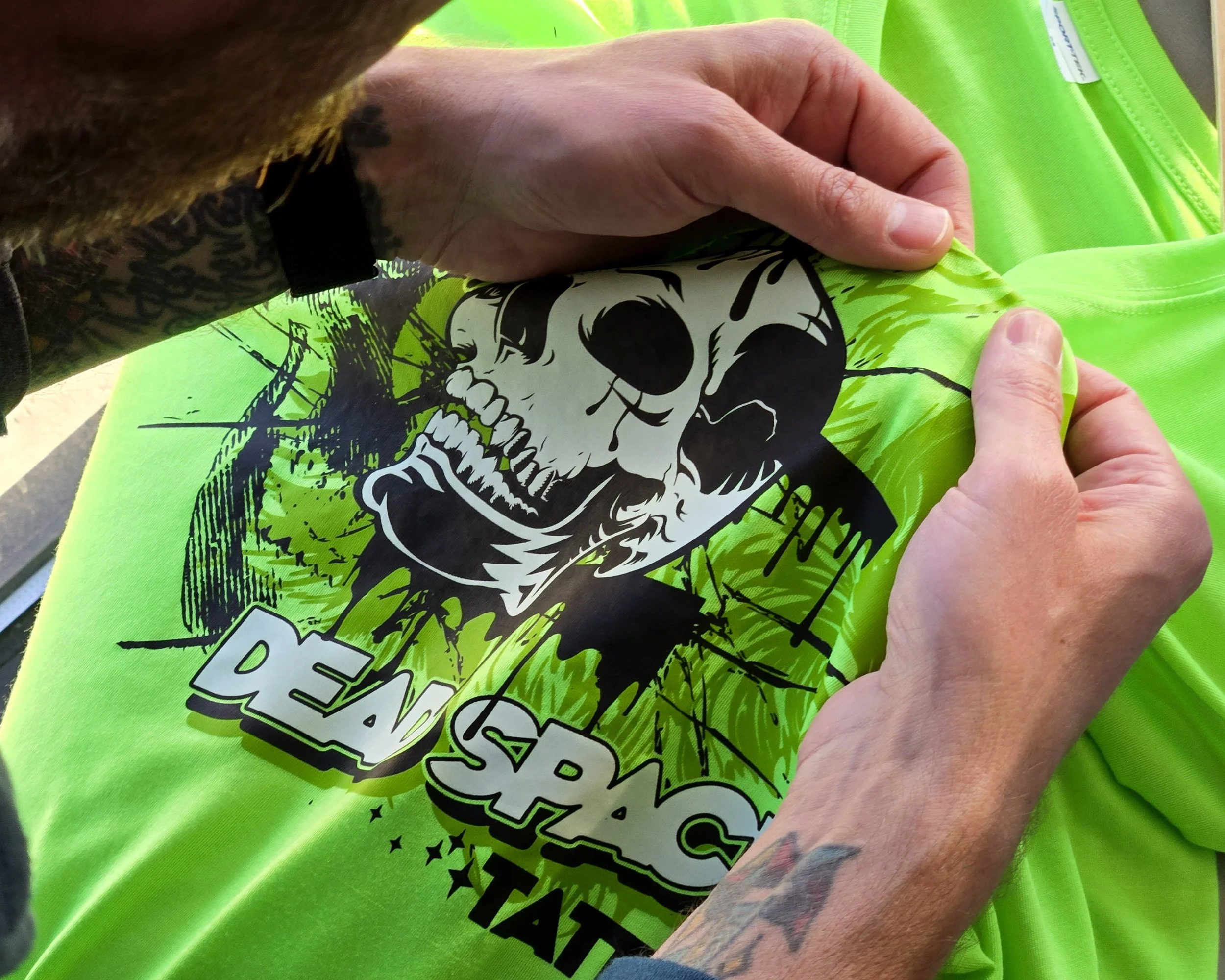 Customer feeling a Glow in the Dark specialty finish on a showroom sample, illustrating Good, Better, Best options with varying visual impact and premium finishes.