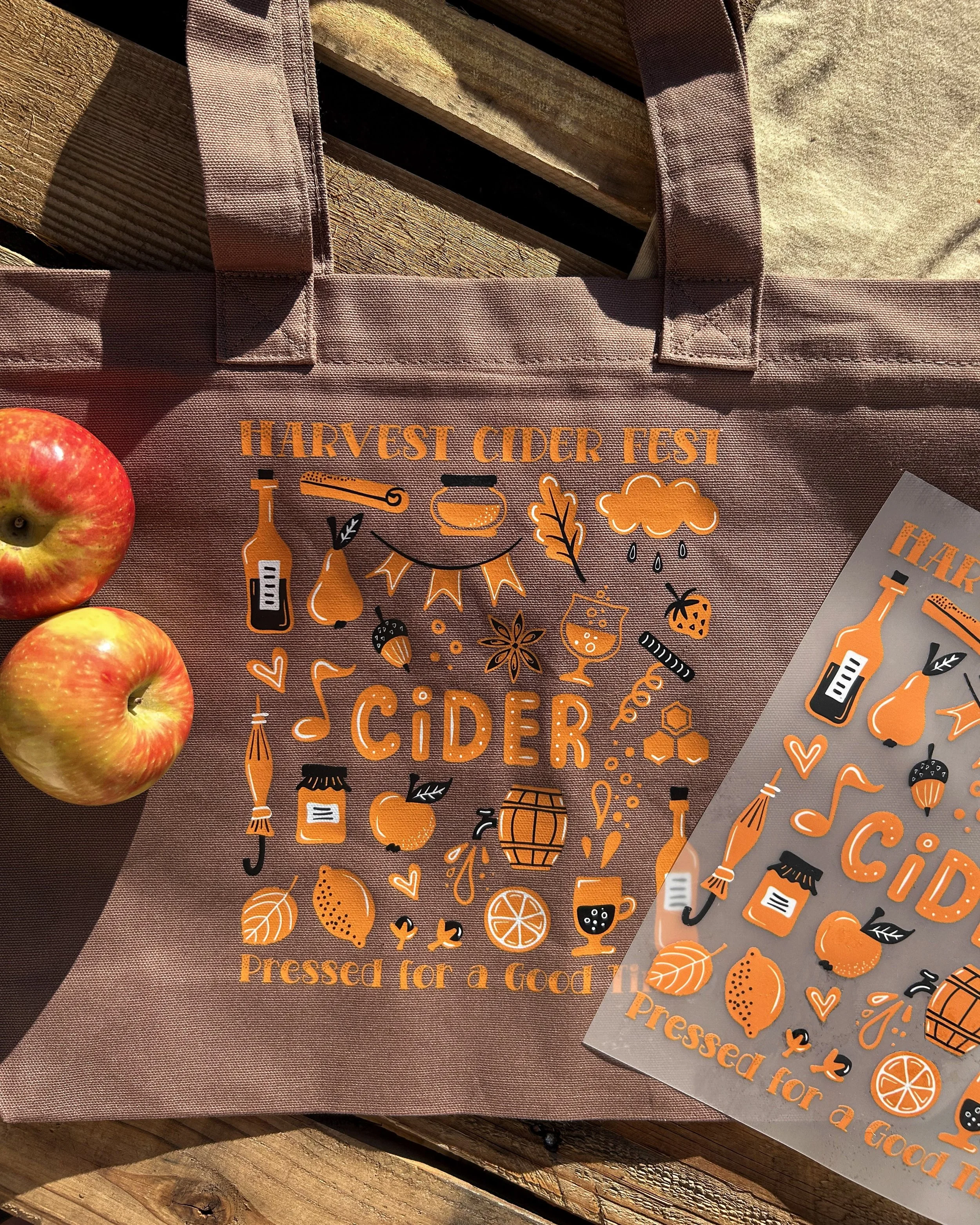Harvest Cider Fest colorVIBE DTF artwork on a brown Comfort Colors tote, styled with apples and a matching transfer.