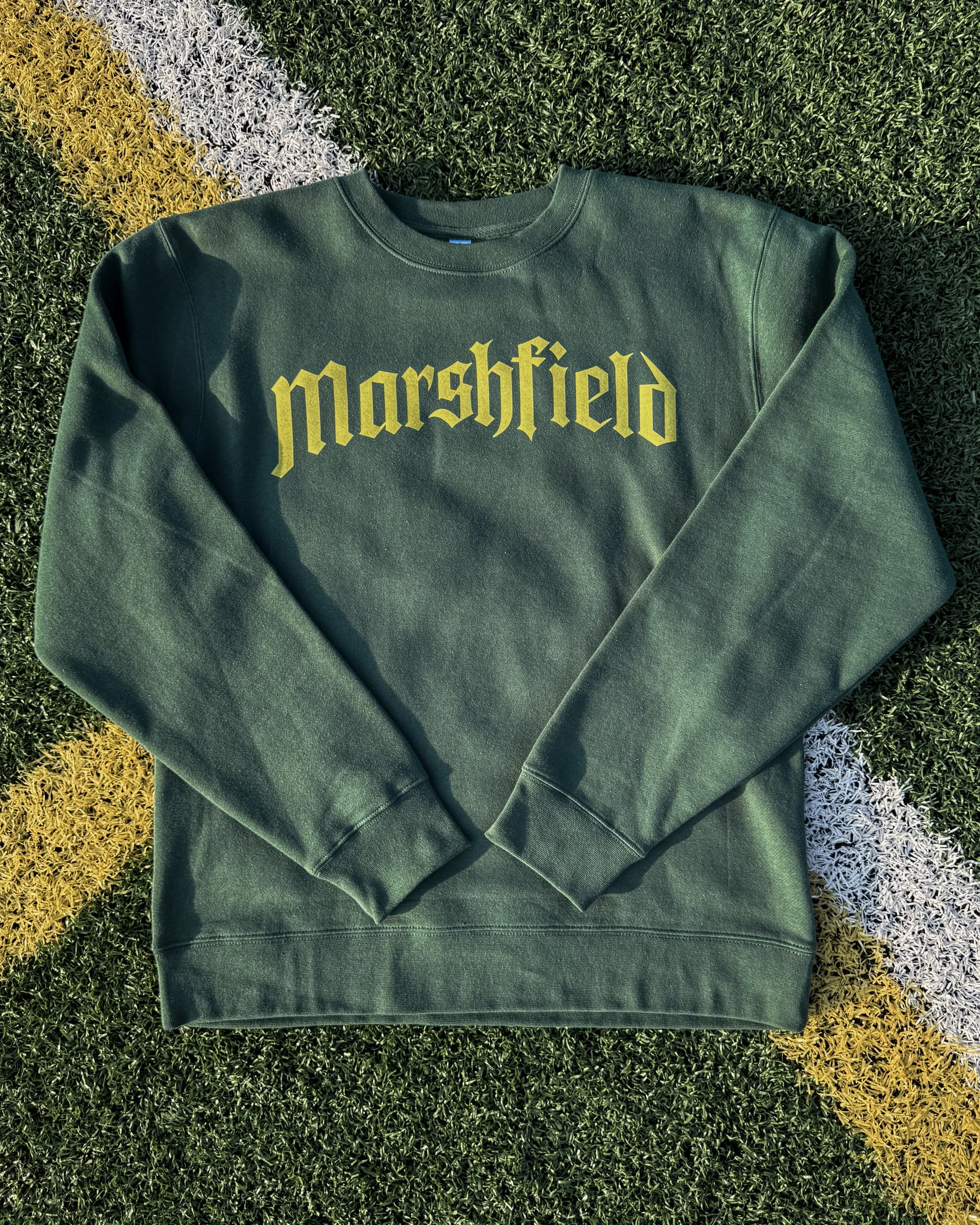Crewneck sweatshirt with typographic school name printed in Vintage Wash screen printed heat transfers, showing soft faded ink texture and retail-inspired finish