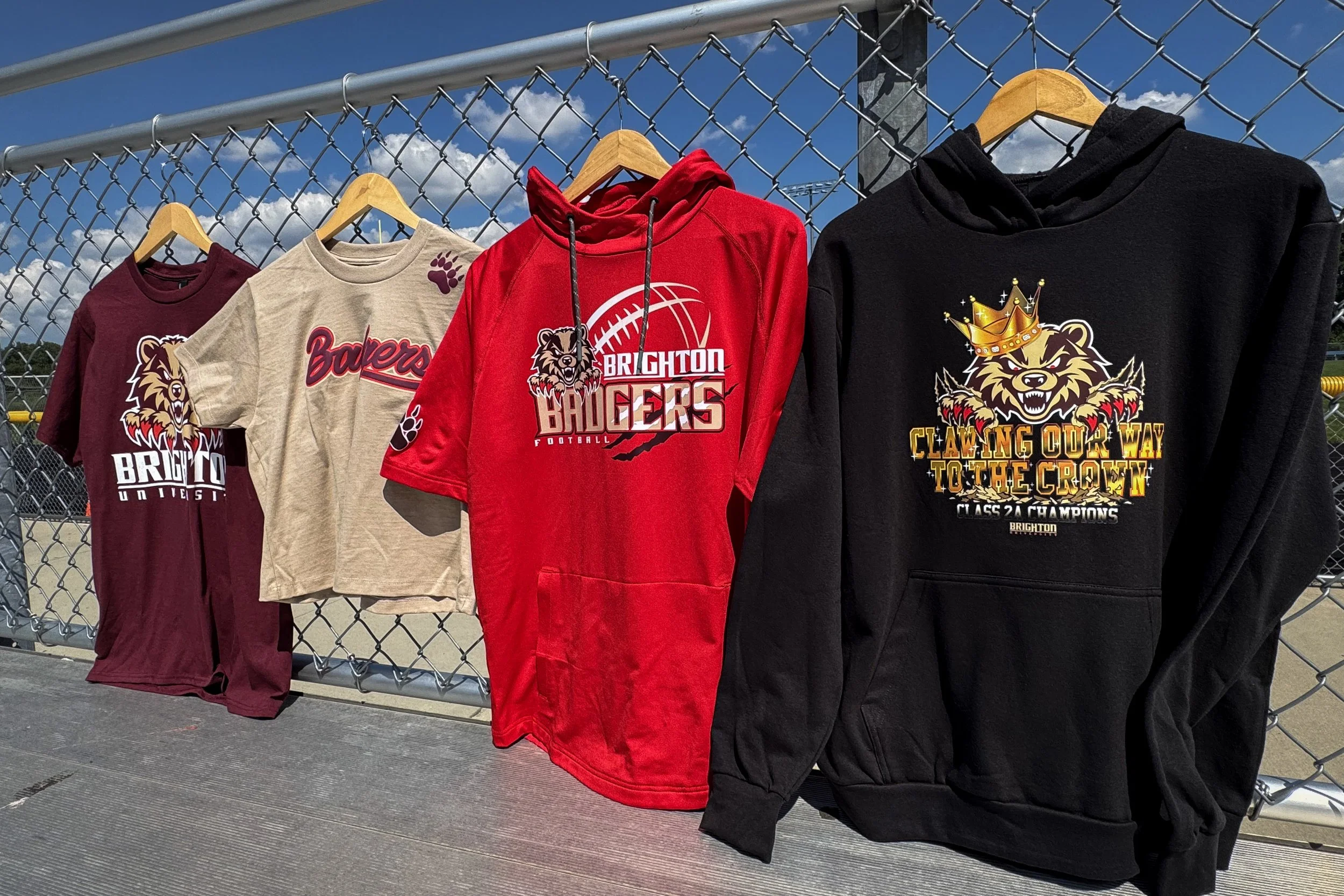 Four coordinated Brighton Badgers team wear pieces decorated with heat transfers across distinct garment styles