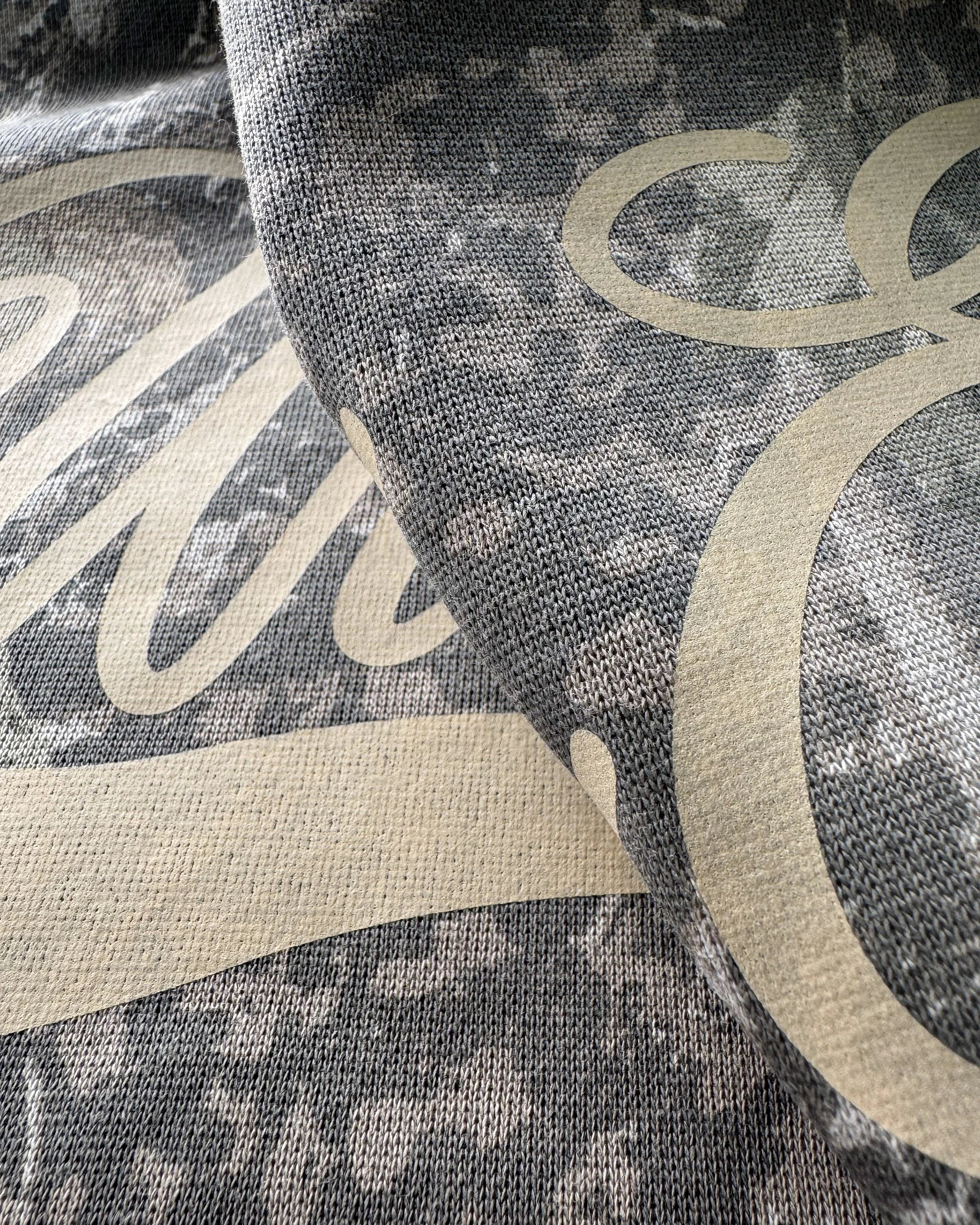 Close-up of Light Tan Vintage Wash lettering with Deadwood Tree camo showing through the print.