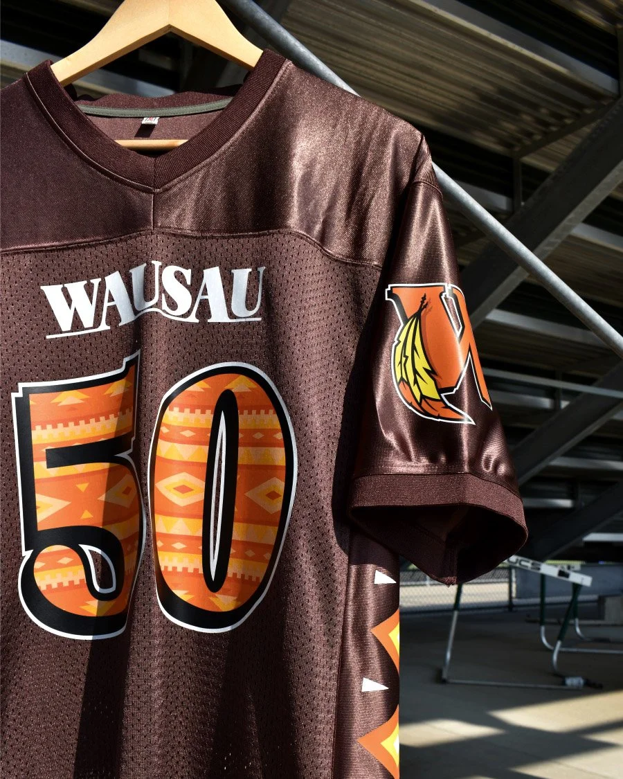 Modern football jersey in rich fall colors displayed as part of a school spirit and team merch collection