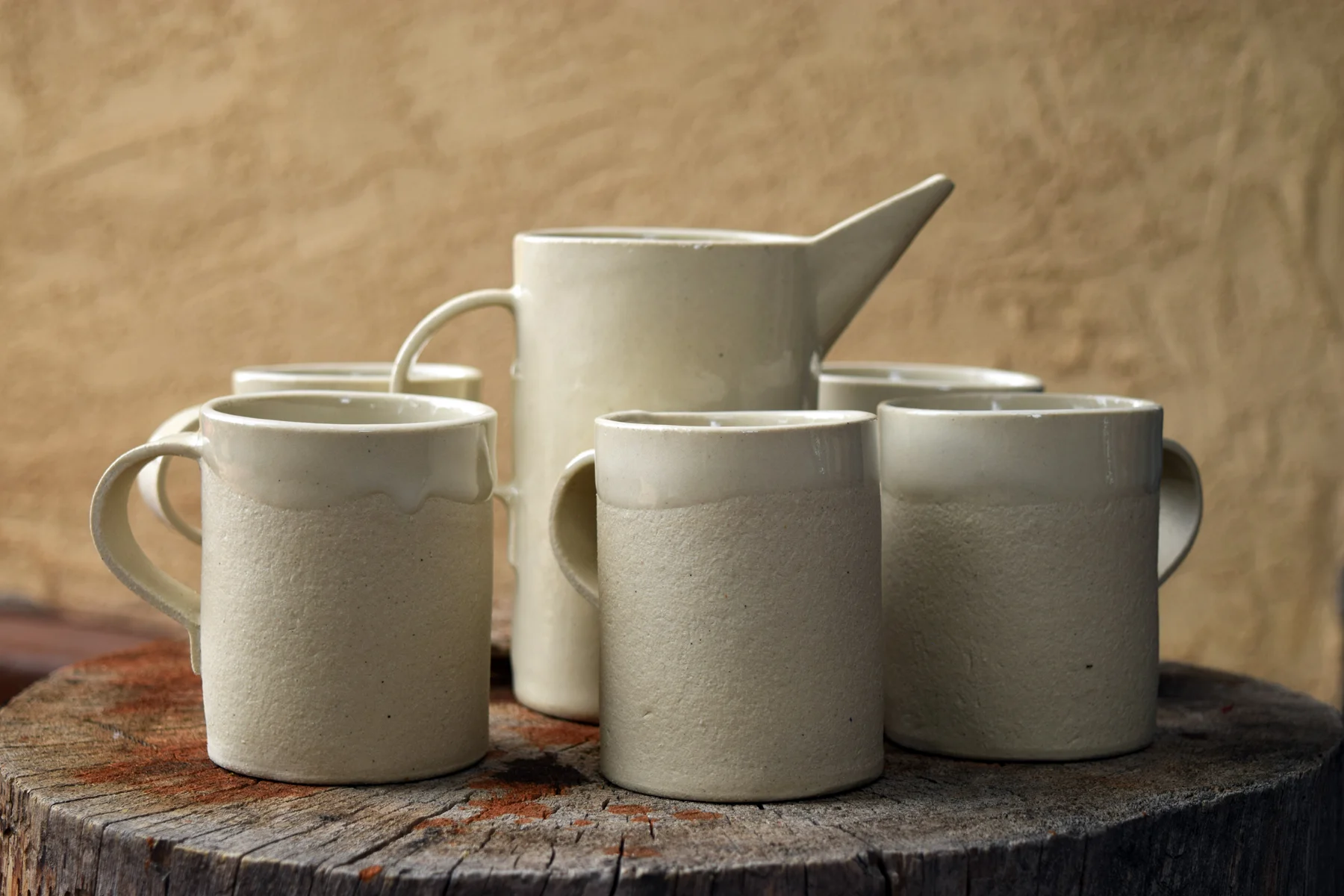 Mugs and pitcher or caraffe