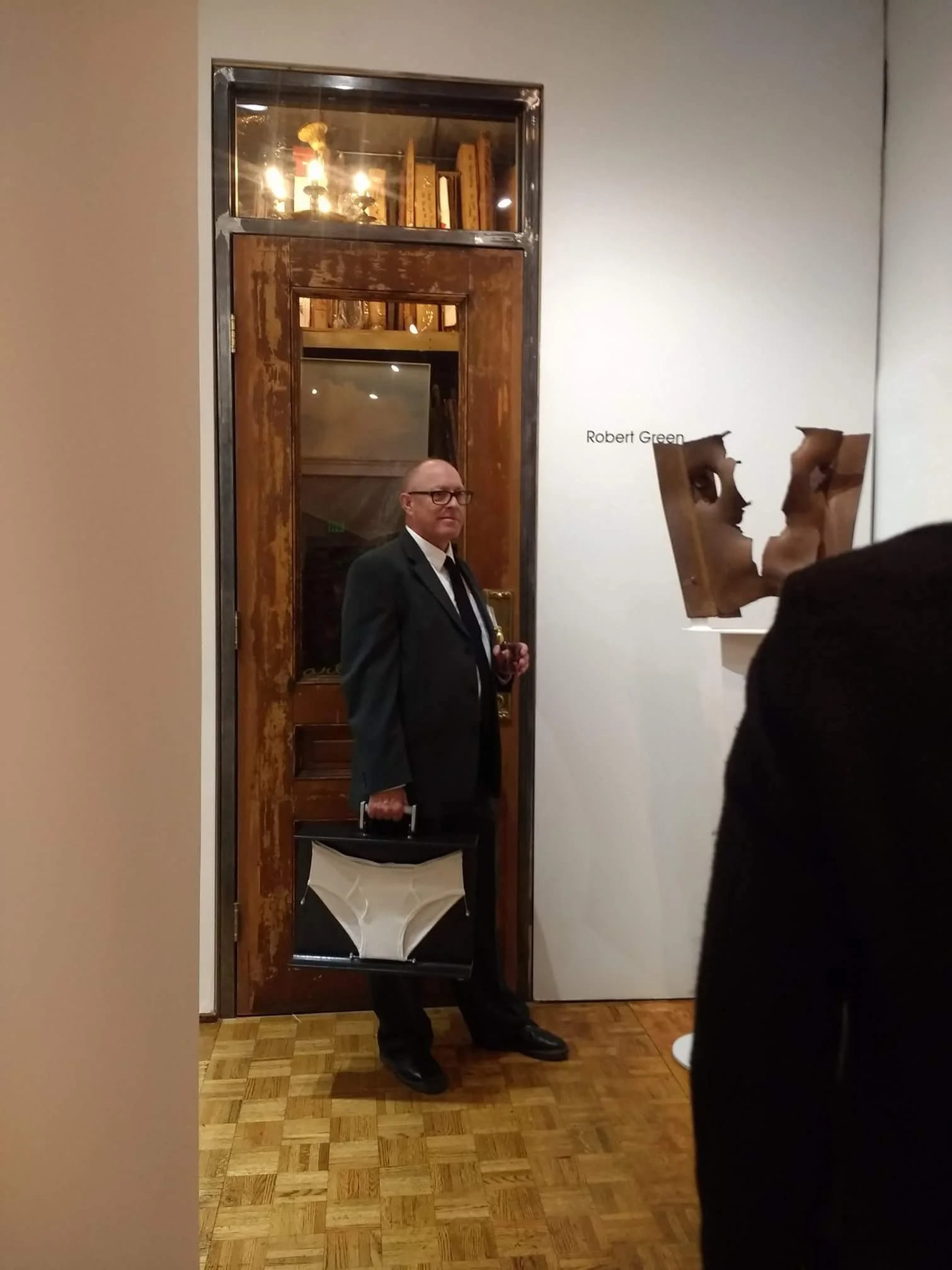 Robert Green hamming it up next to his sculpture at the opening party