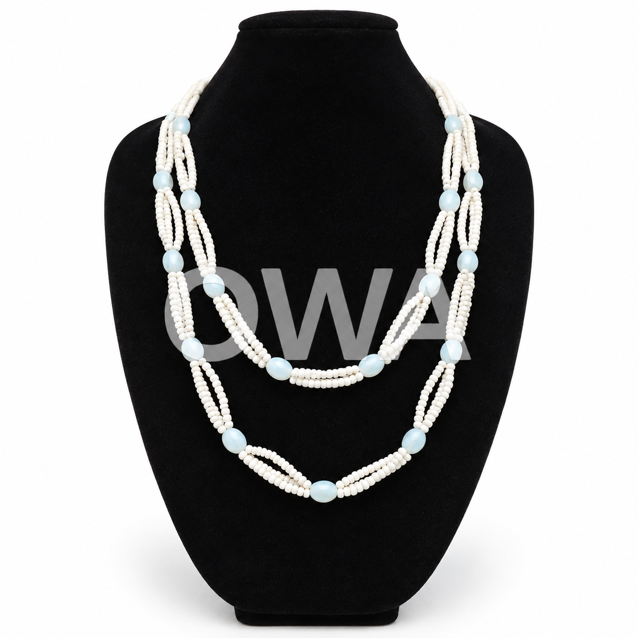 Layered Blue Beaded Necklace on Velvet Bust.png