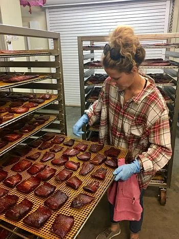 Amanda processing smoked salmon in Ronan, MT