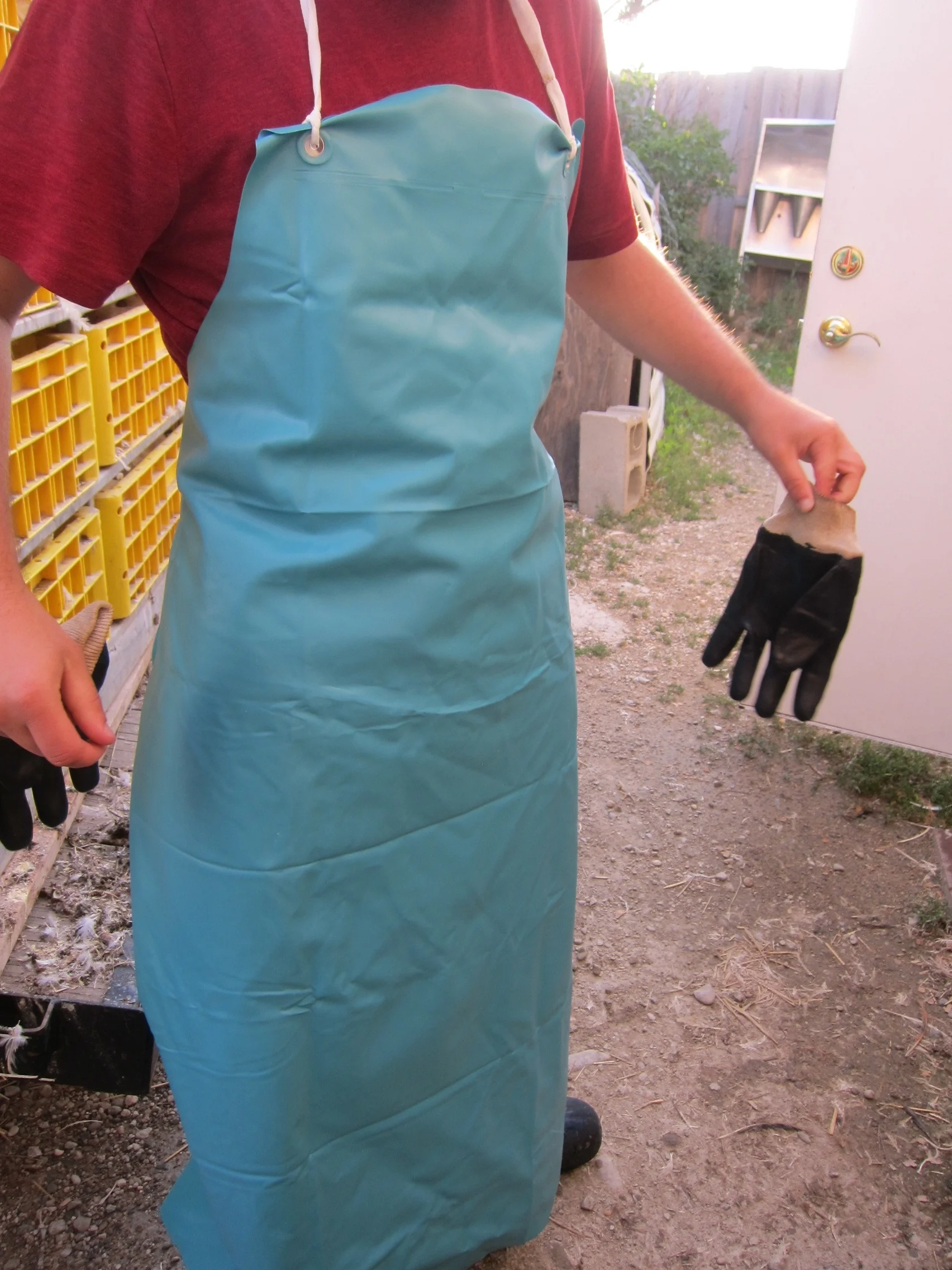 A worker showing off his rubber apron. I wish I had these for processing at home!