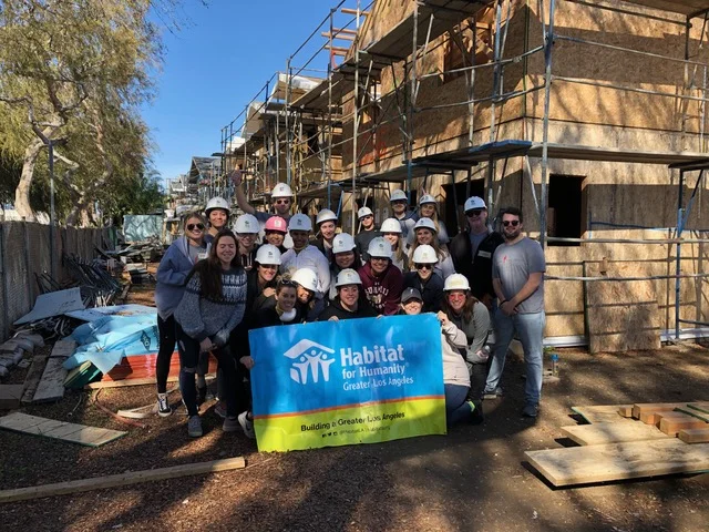 Denise and the Paradigm team volunteering with Habitat for Humanity.