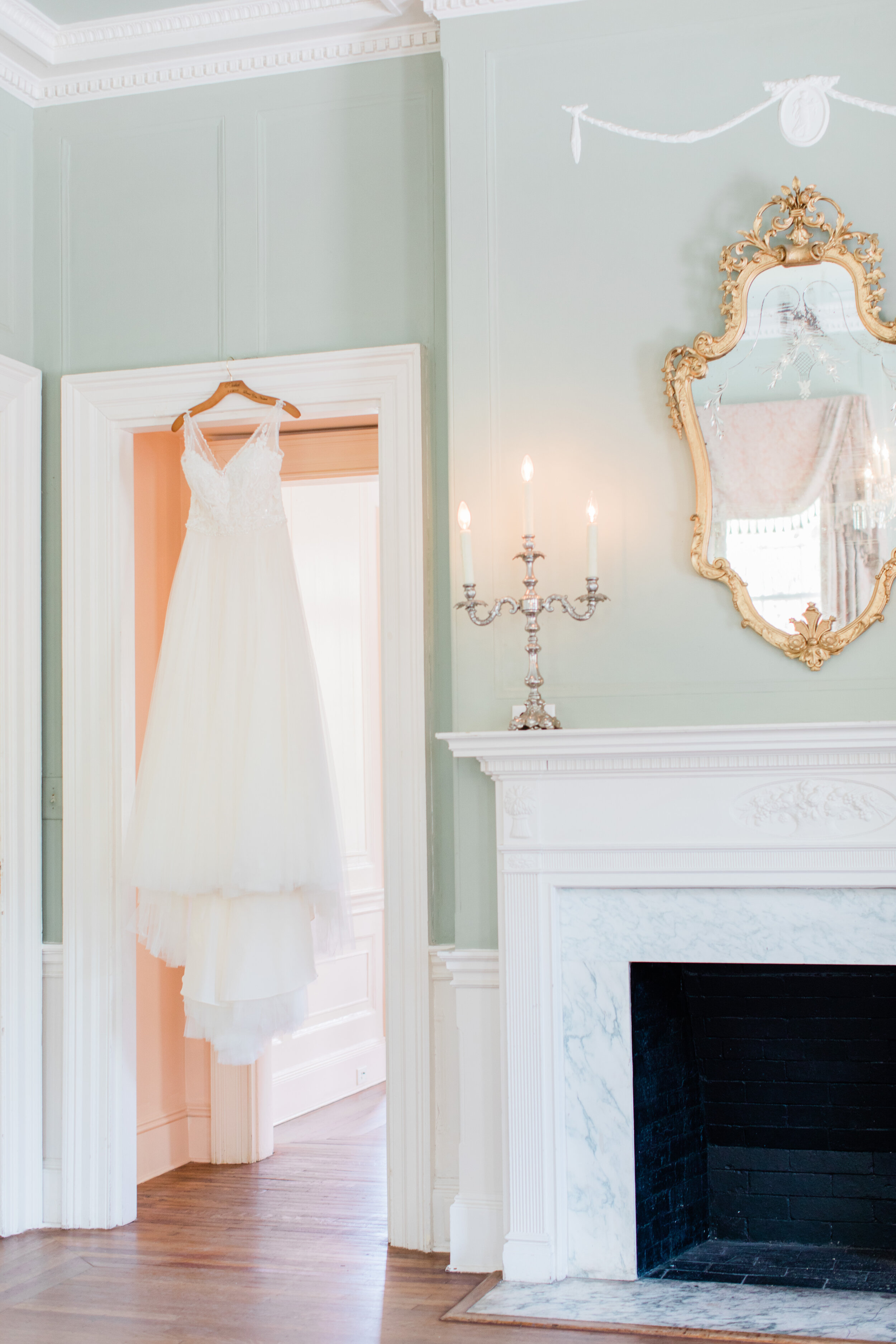 Ford wedding - dress hanging in doorway - Lowdnes Grove - Ava Moore Photography - Charleston Wedding Planner.jpg
