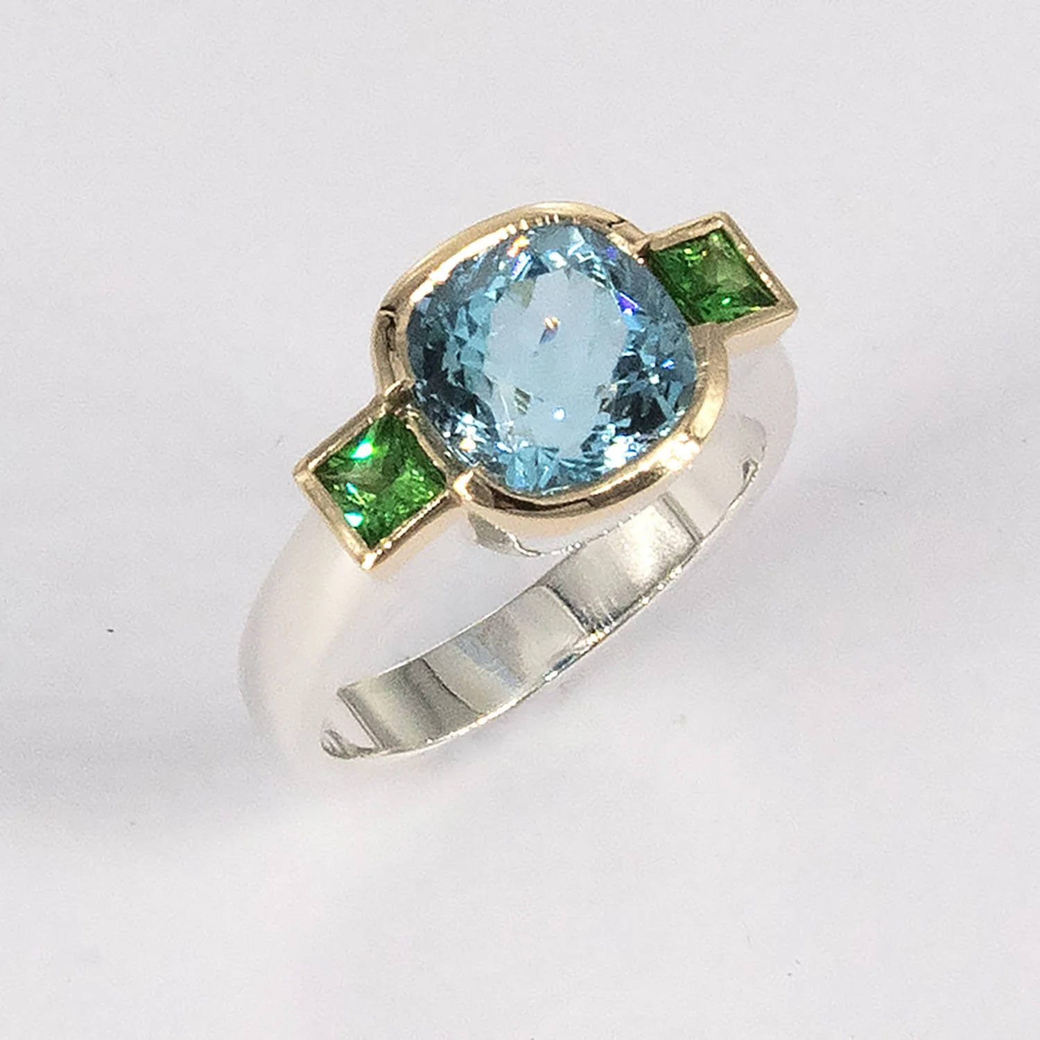 Swiss blue topaz and tsavorite gold and silver ring